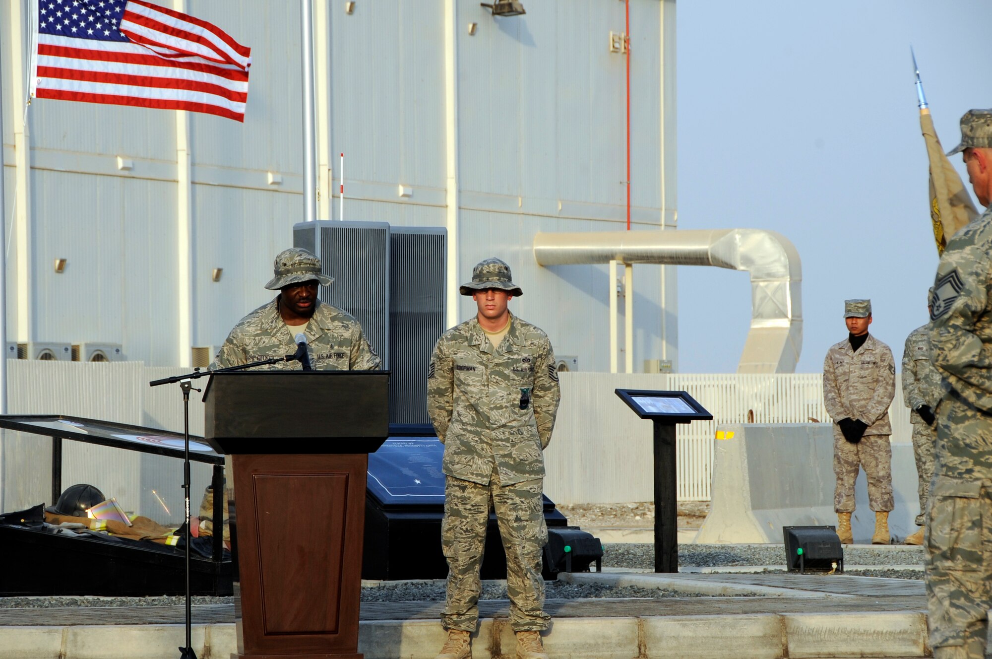 SOUTHWEST ASIA – Staff Sgt. Eric Otoo, 380th Expeditionary Medical Group, recites the Medic’s Prayer during a commemoration ceremony here on the eighth anniversary of Sept. 11, 2001. The plaque at the base of the towers is titled, “We Remember.” (U.S. Air Force photo/Senior Airman Stephen Linch)