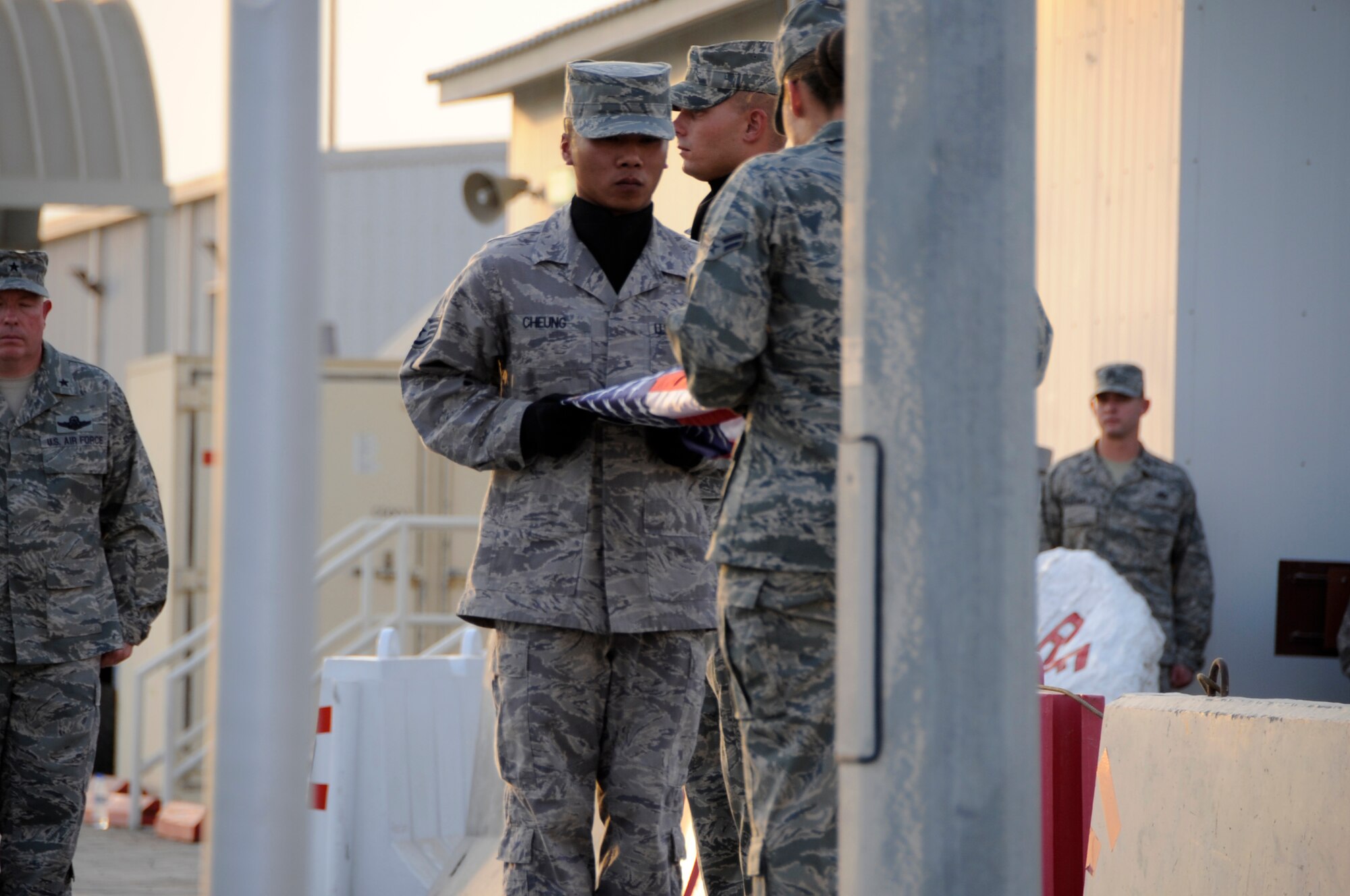 SOUTHWEST ASIA – 380th Air Expeditionary Wing Honor Guard members fold the flag during a commemoration ceremony here on the eighth anniversary of Sept. 11, 2001. Approximately 450 Airmen and Soldiers participated in the event. (U.S. Air Force photo/Senior Airman Stephen Linch)