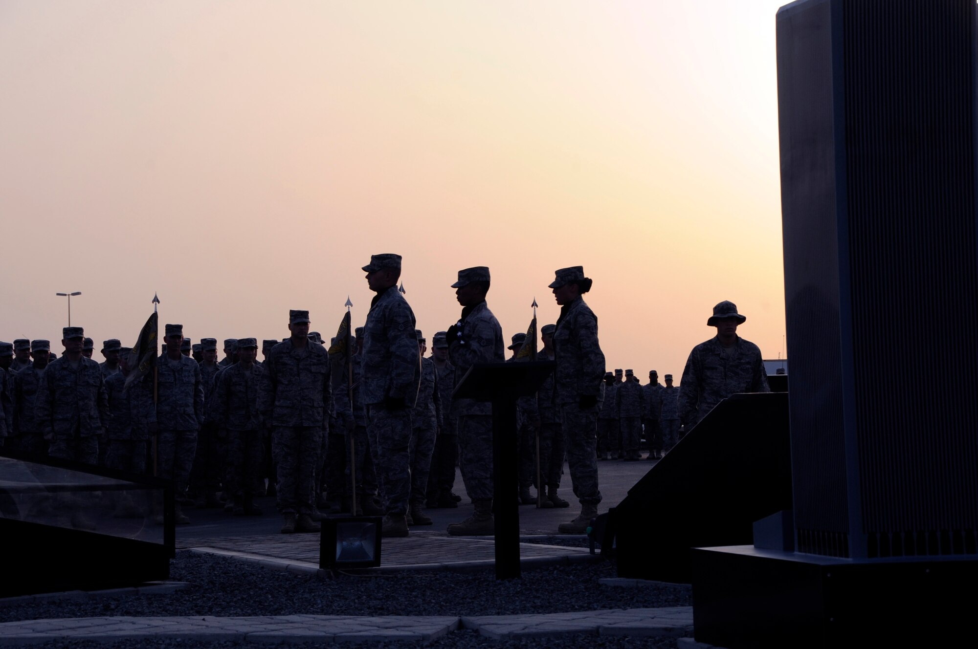 SOUTHWEST ASIA – 380th Air Expeditionary Wing Honor Guard members retire the flag during a commemoration ceremony on the eighth anniversary of Sept. 11, 2001, as Airmen and Soldiers stand in formation, here Sept. 11, 2009. 380th AEW Airmen recently spent more than 1,000 man hours rebuilding the 380th AEW’s Sept. 11 memorial. (U.S. Air Force photo/Senior Airman Stephen Linch)