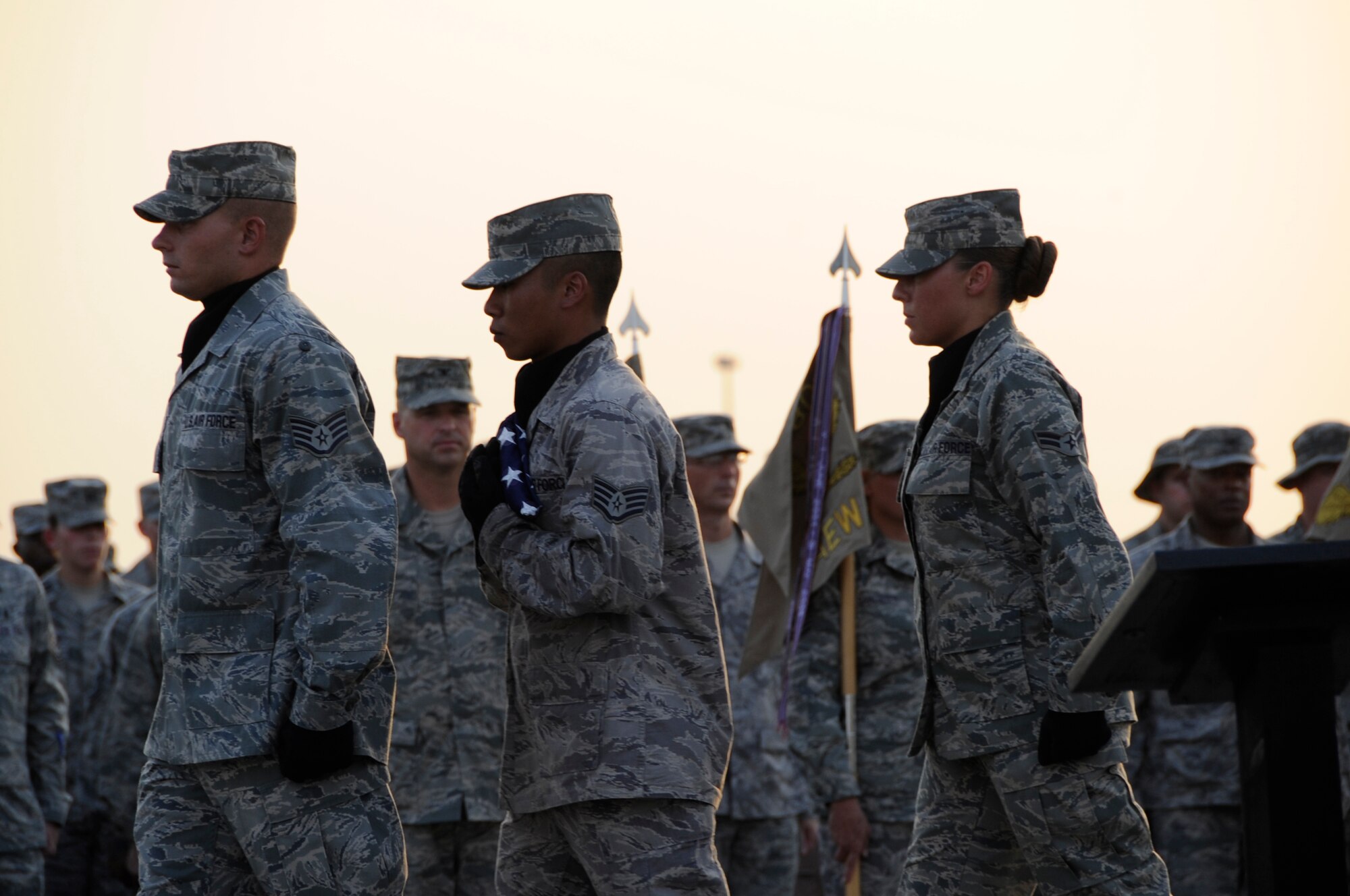 SOUTHWEST ASIA – 380th Air Expeditionary Wing Honor Guard members retire the flag during a commemoration ceremony marking the eighth anniversary of Sept. 11, 2001, as Airmen and Soldiers stand in formation here, Sept. 11, 2009. The 380th AEW is home to KC-10s, U-2s, Global Hawks and E-3 Sentry's, and provides aerial refueling, intelligence, surveillance, reconnaissance and air battle management to OPERATIONS ENDURING AND IRAQI FREEDOM. (U.S. Air Force photo/Senior Airman Stephen Linch)