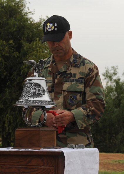 DYESS AIR FORCE BASE, Texas – Dyess Chaplain (Capt.) Gildardo Garcia rings a ceremonial bell here Sept. 11 to honor the victims of the Sept. 11 terrorist attacks. The tolling of the bell symbolized the exact moments the terrorist attacks hit the World Trade Center, N.Y., Pentagon and Pennsylvania field with two additional chimes signifying the collapsing of the World Trade Center twin towers. (U.S Air Force photo by Senior Airman Jennifer Romig)