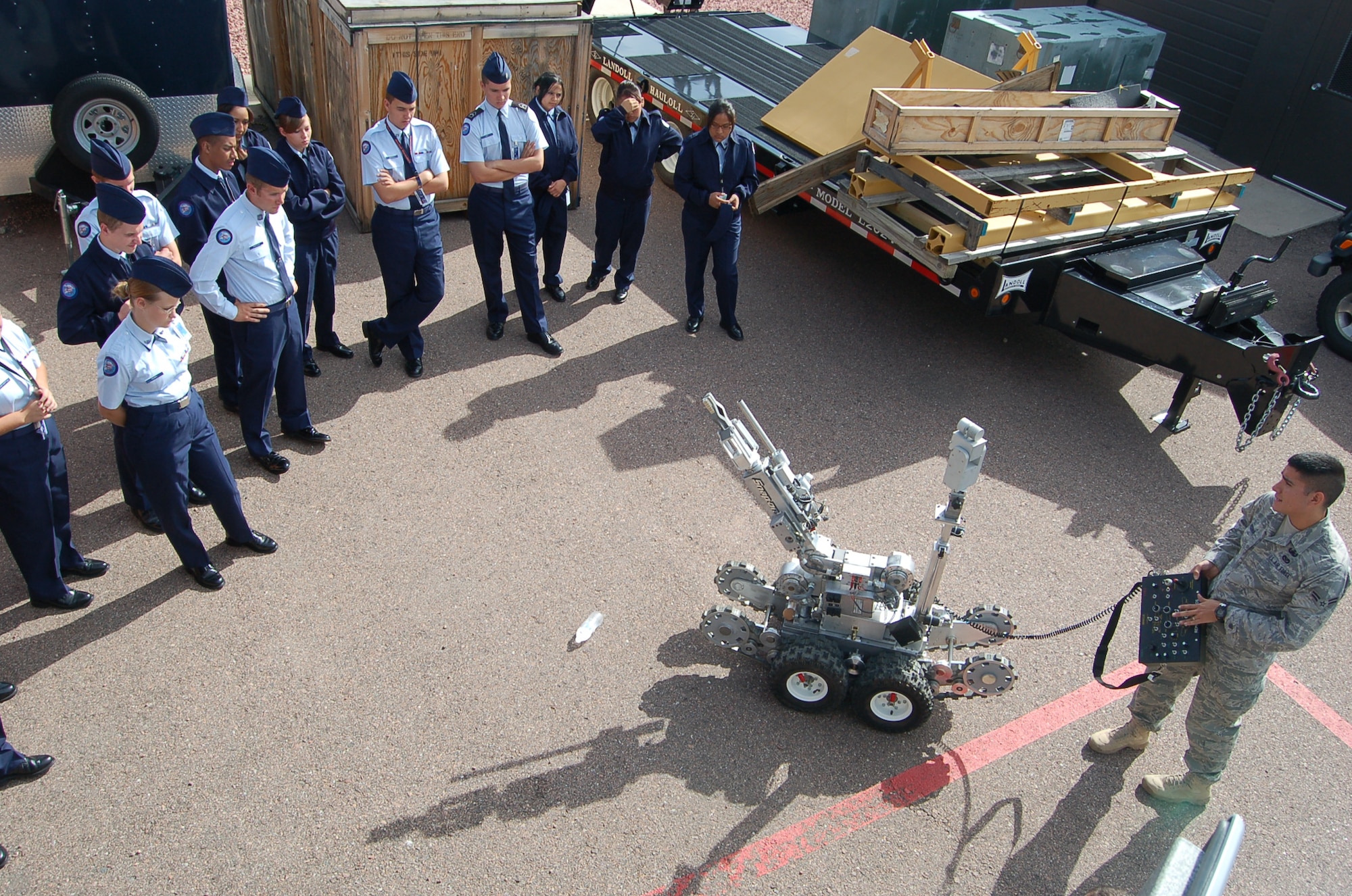 Mitchell High School Junior Reserve Officer Training Corps Cadets participate in a demonstration of the F6A robot at the Explosive Ordnance Disposal Flight at the 302nd Logistics Readiness Squadron building Sept. 10. Airmen First Class John Medina, 21st Civil Engineering Squadron EOD journeyman, operates the robot that is used to avoid putting EOD Airmen in harm’s way. (Air Force photo by Thea Skinner)