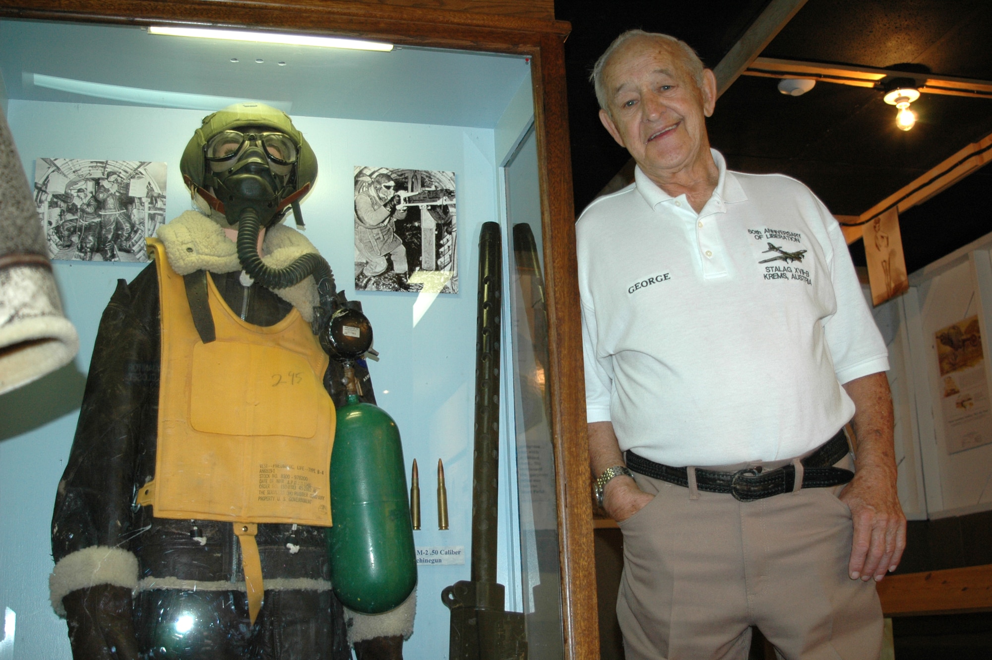 George Jahnke poses next to B-17 gunner's equipment at the Malmstrom Museum. Mr. Jahnke was the right wing waist gunner on board B-17E "Patches" and flew 13 combat missions over Germany. The Airman bailed out of Patches on the 13th mission and landed on top of a German farmer. He was then taken to a German POW camp where he stayed for nearly two years before escaping to allied territory. The retired Air Force master sergeant trained at Malmstrom in 1943 and now makes his home in Augusta, Mont. (U.S. Air Force photo/Senior Airman Dillon White)