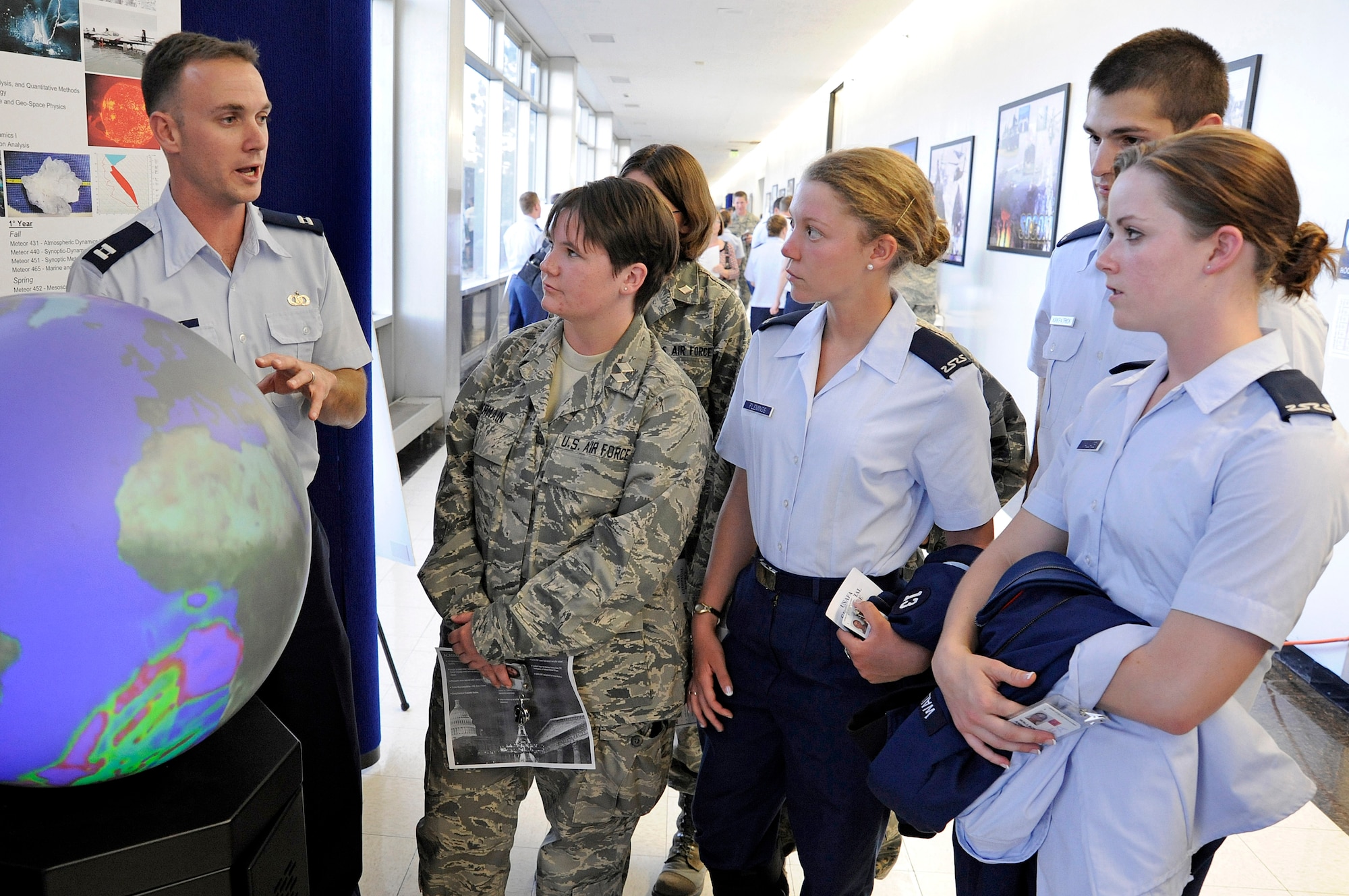 Physics instructor Capt. Paul Homan briefs cadets about the weather sphere during Majors Night Sept. 9, 2009. The sphere emulates how waves propagate through the atmosphere much the same way they do through the ocean. (U.S. Air Force photo/Mike Kaplan)