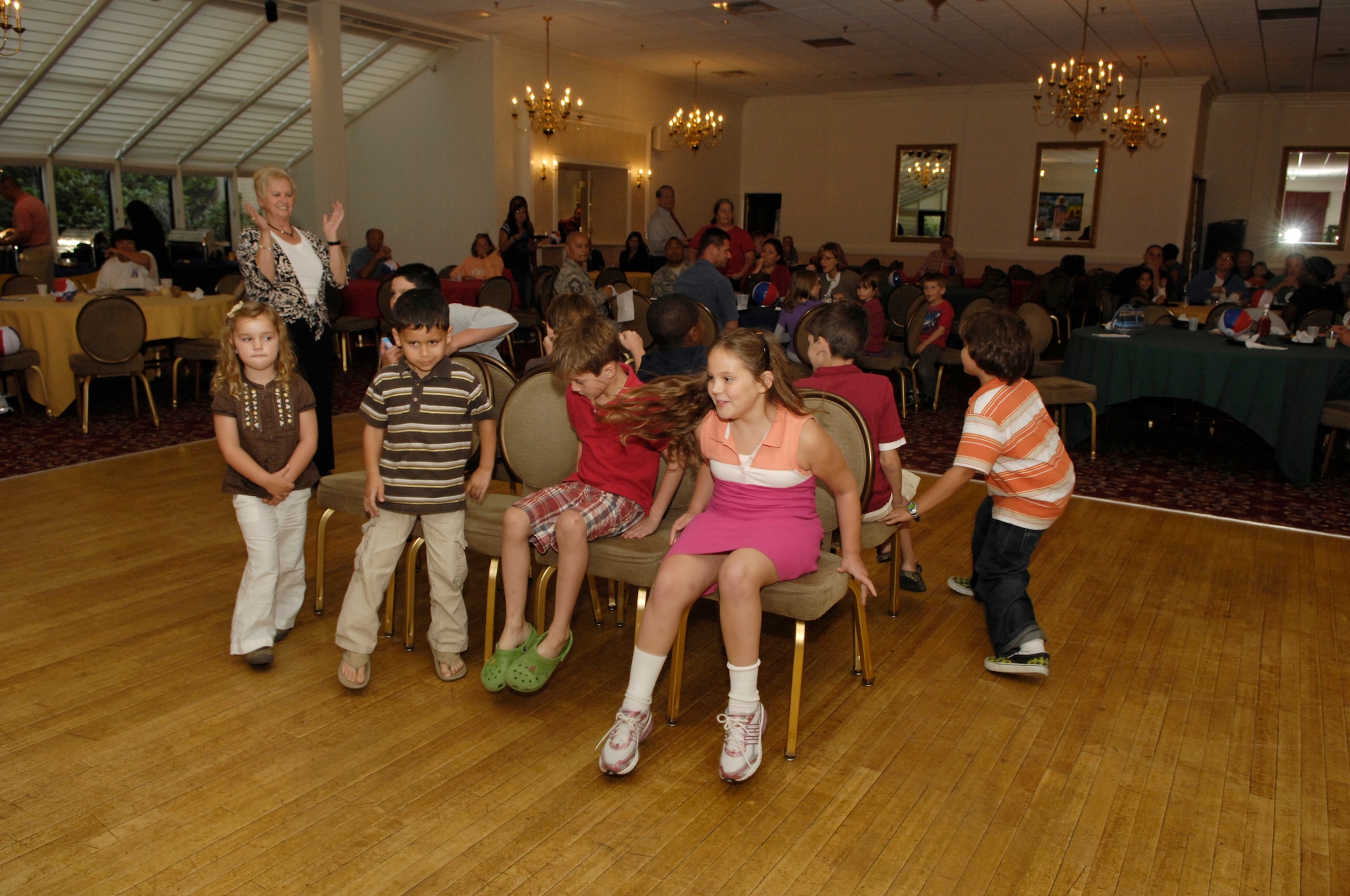 HANSCOM AIR FORCE BASE, Mass. – Children attending the Back to School Blues family night at the Minuteman Club on Sept. 9, take part in a game of musical chairs. The event was for Club members and featured a number of games, activities and giveaways for families to participate in. For more information on becoming a Club member or for a list of upcoming activities at the Club go to www.hanscomservices.com. (U.S. Air Force photo by Mark Herlihy)