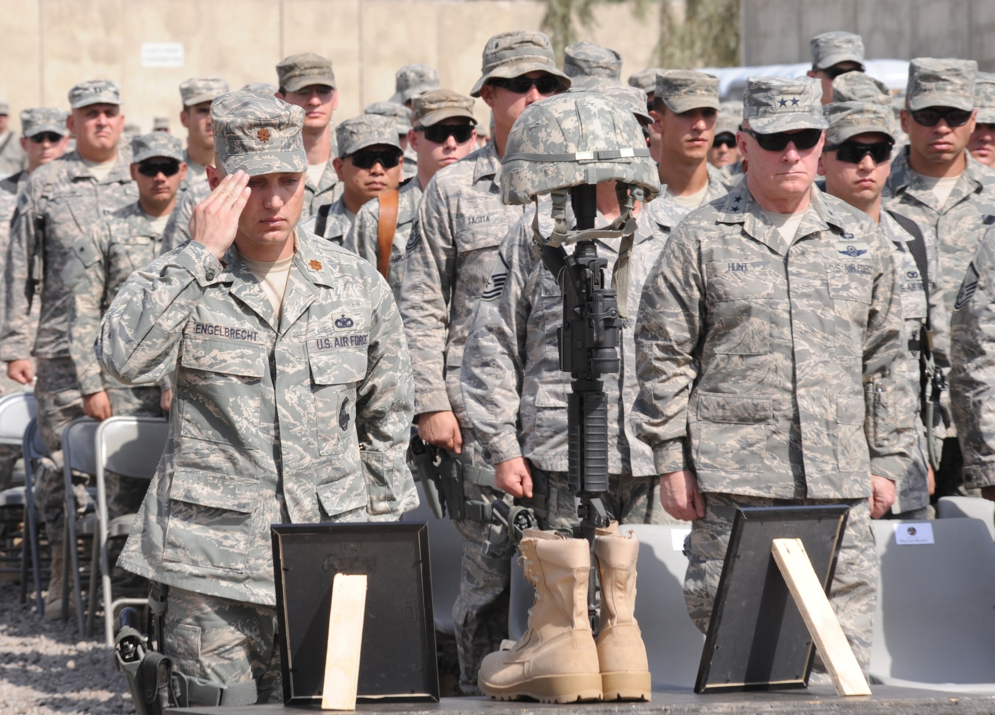 Maj. Joseph Engelbrecht salutes a memorial to 1st Lt. Joseph D. Helton, Jr. after posthumously presenting him a Bronze Star with valor device during a ceremony at Camp Stryker, Iraq, Sept. 12, 2009. Lieutenant Helton, a flight commander for the 732nd Expeditionary Security Forces Squadron Detachment 2, was killed Sept. 8, 2009, by an improvised explosive device while leading his team on a mission in Baghdad. Major Engelbrecht is the 732nd ESFS Det. 2 commander. (U.S. Air Force photo/Tech. Sgt. Johnny L. Saldivar) 