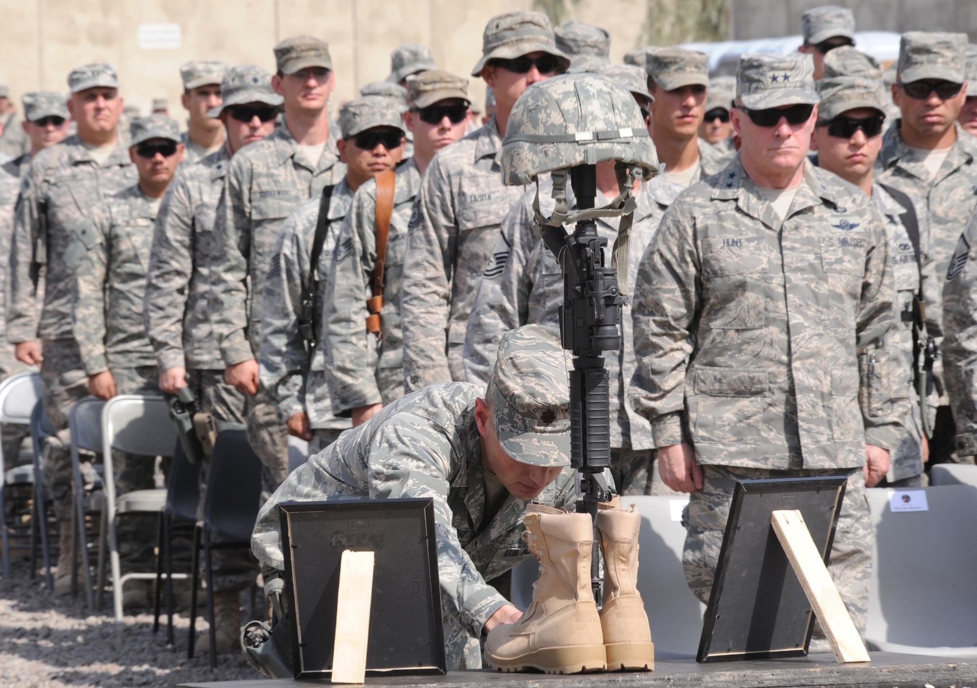 Maj. Joseph Engelbrecht posthumously presents 1st Lt. Joseph D. Helton, Jr. a Bronze Star with valor device during a memorial ceremony held at Camp Stryker, Iraq, in his honor Sept. 12, 2009.  Lieutenant Helton, a flight commander for the 732nd Expeditionary Security Forces Squadron Detachment 2 and a 2007 graduate of the U.S. Air Force Academy, was killed Sept. 8, 2009, by an improvised explosive device while leading his team on a mission in Baghdad. (U.S. Air Force photo/Tech. Sgt. Johnny L. Saldivar)   