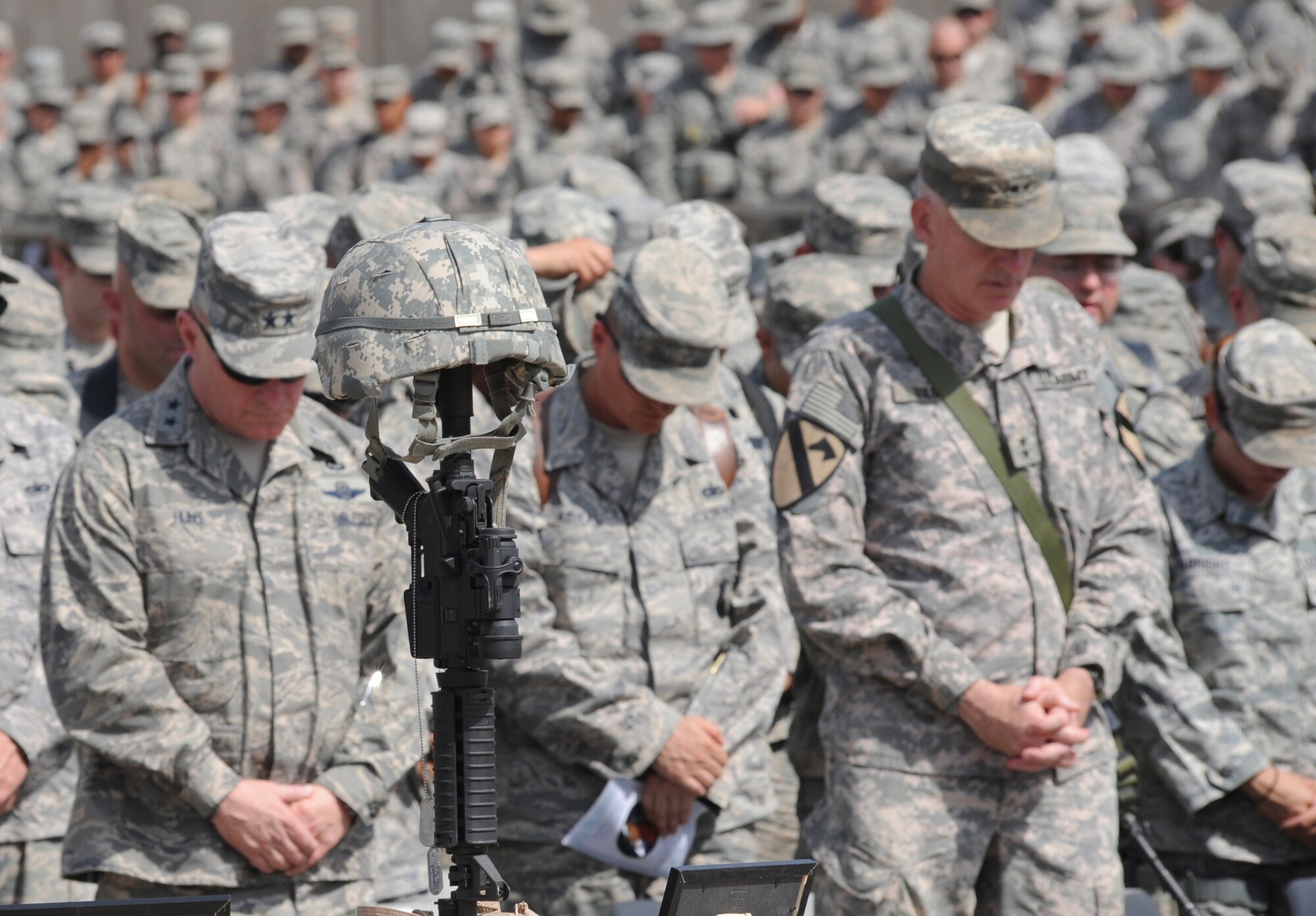 Servicemembers from the Victory Base Complex near Baghdad attend a memorial ceremony for 1st Lt. Joseph D. Helton, Jr. Sept. 12, 2009. Lieutenant Helton, a flight commander for the 732nd Expeditionary Security Forces Squadron Detachment 2 Police Transition Team and a 2007 graduate of the U.S. Air Force Academy, was killed Sept. 8, 2009, by an improvised explosive device while leading his team on a mission in Baghdad. (U.S. Air Force photo/Tech. Sgt. Johnny L. Saldivar)   