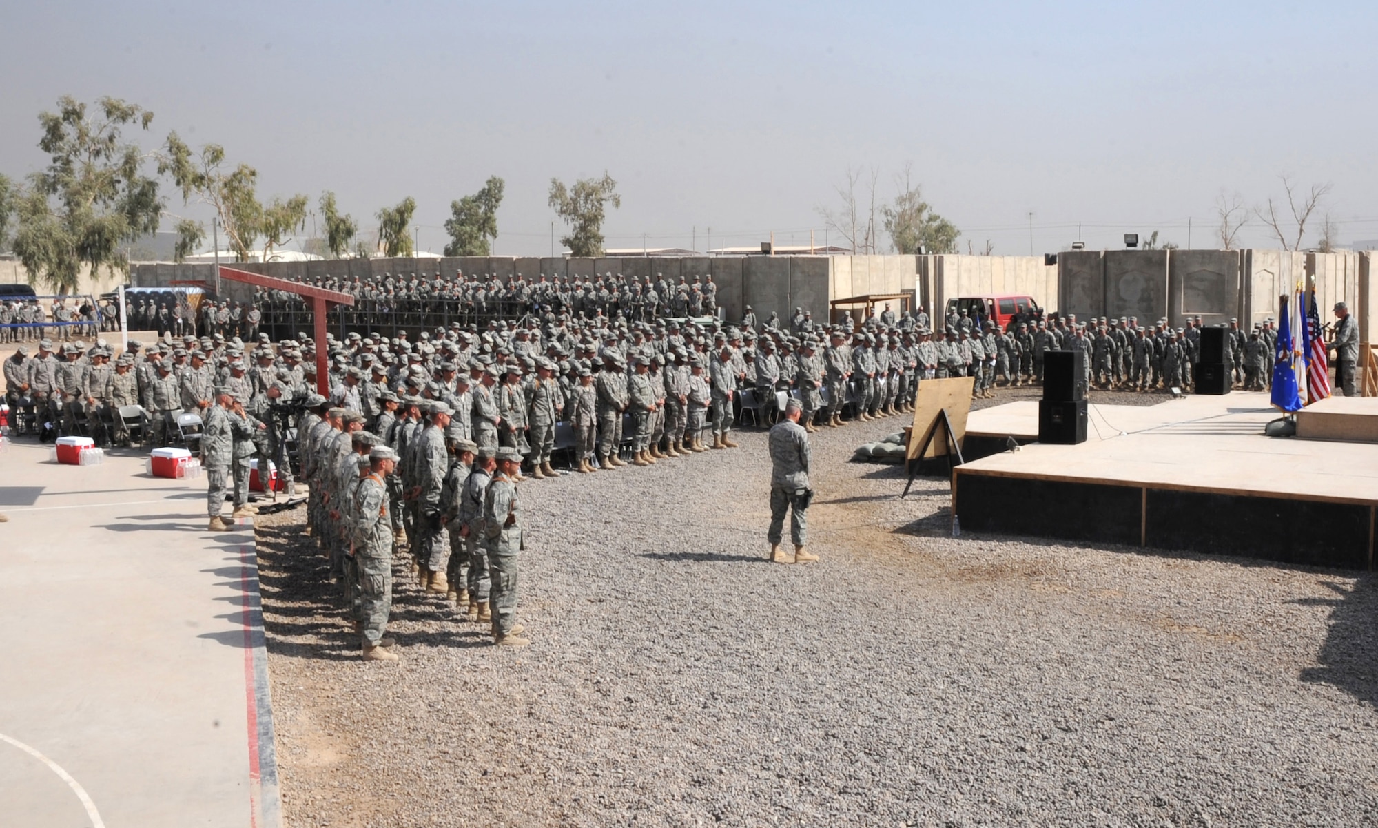 Servicemembers from the Victory Base Complex near Baghdad attend a memorial ceremony held to honor 1st Lt. Joseph D. Helton, Jr. Sept. 12, 2009. Lieutenant Helton, a flight commander for the 732nd Expeditionary Security Forces Squadron, Detachment 2 Police Transition Team and a 2007 graduate of the U.S. Air Force Academy, was killed Sept. 8, 2009, by an improvised explosive device while leading his team on a mission in Baghdad. (U.S. Air Force photo/Tech. Sgt. Johnny L. Saldivar)   