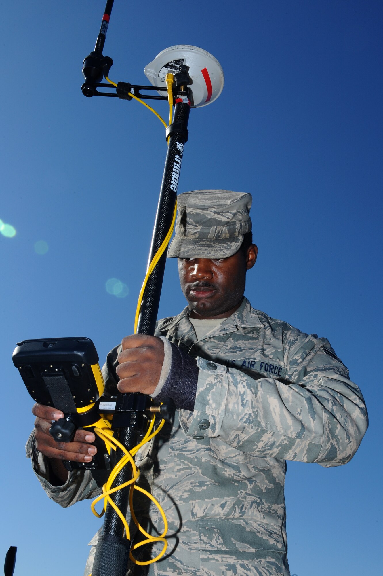 Airman 1st Class Wesley Nesbitt, 28th Civil Engineer Squadron engineer technician, uses a survey rover to measure sidewalks, curbs and gutters here, Sept. 10. Airman Nesbitt will use the measurements to update the installation map for accuracy in future construction. (U.S. Air Force photo/Senior Airman Kasey Zickmund)
