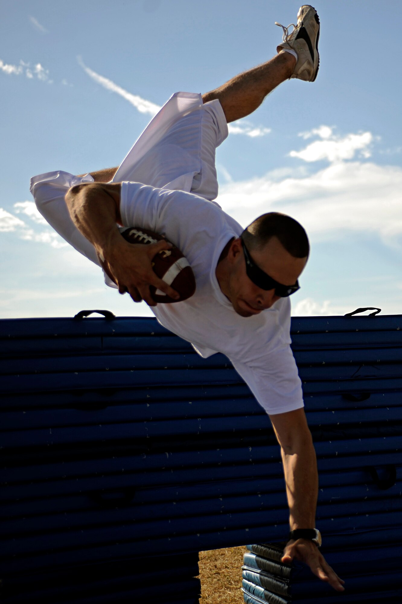 Airman 1st Class William Broullire, 28th Logistics Readiness Squadron vehicle operations technician, participates in a fourth and goal scenario during a football competition held here, Sept. 10. The event tested the participants ability to jump over a simulated pile of players into the end zone. The competition was open to the base populace to test various football skills. (U.S. Air Force photo/Airman 1st Class Matthew Flynn)