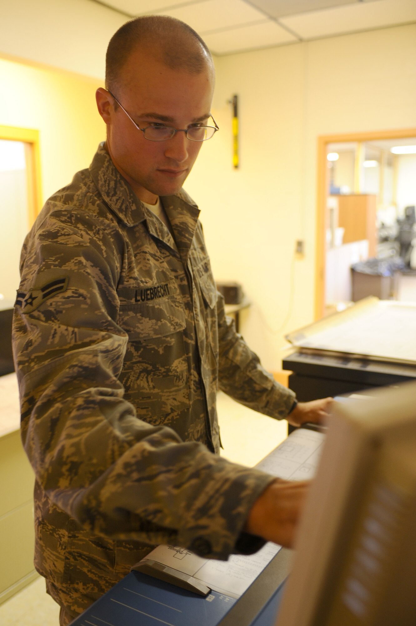 Airman 1st Class Alex Luebrecht, 28th Civil Engineer Squadron engineer technician, inputs data before scanning a floor plan here, Sept. 10. Airman Luebrecht scans the floor plan for easier future access. (U.S. Air Force photo/Senior Airman Kasey Zickmund)