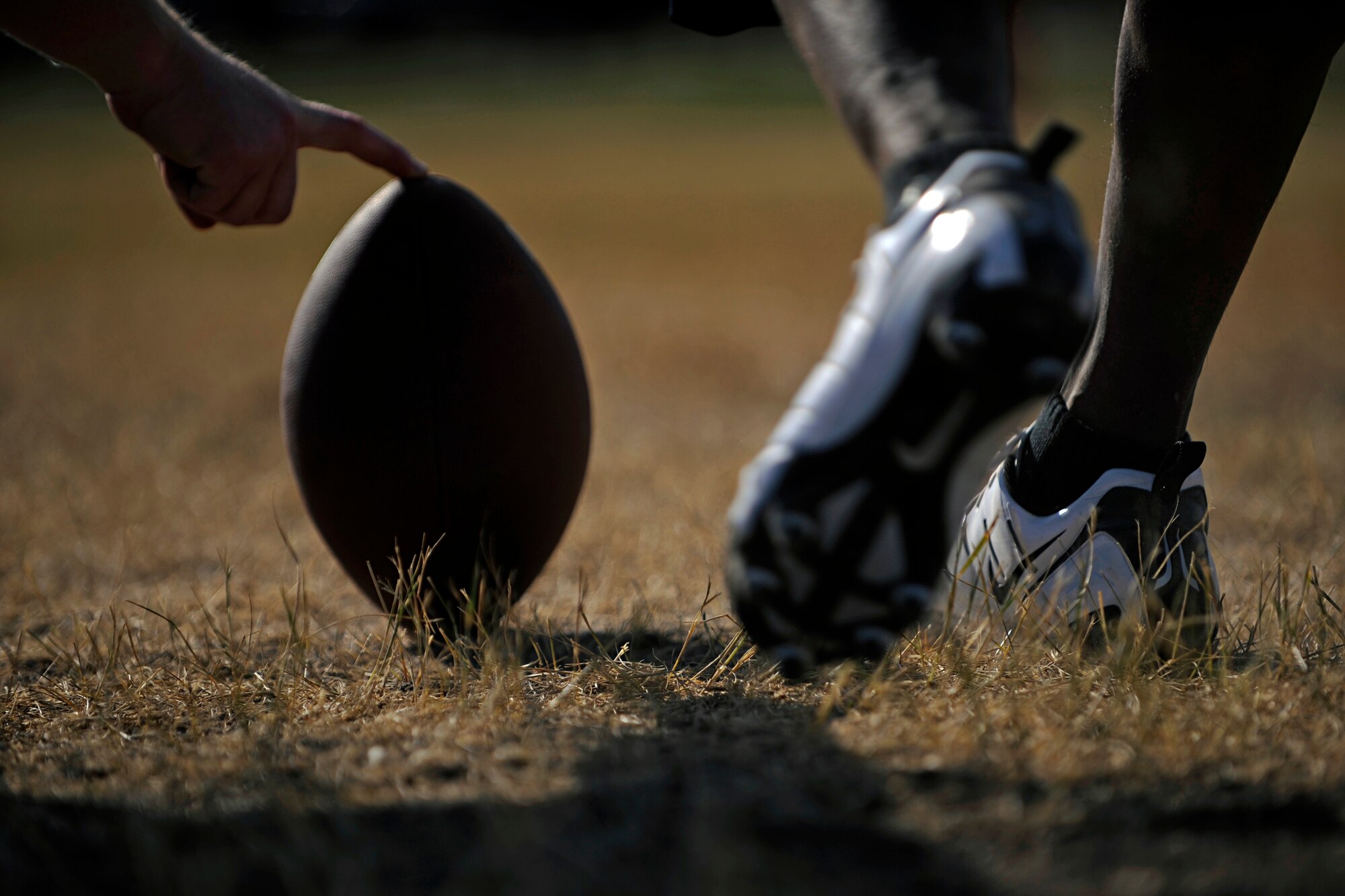 Airman 1st Class Tremain Knowles, 28th Aircraft Maintenance Squadron crew chief, attempts a field goal during a football competition held here, Sept. 10. Airman Knowles won the competition, which was open to the base populace to test various football skills. (U.S. Air Force photo/Airman 1st Class Matthew Flynn)