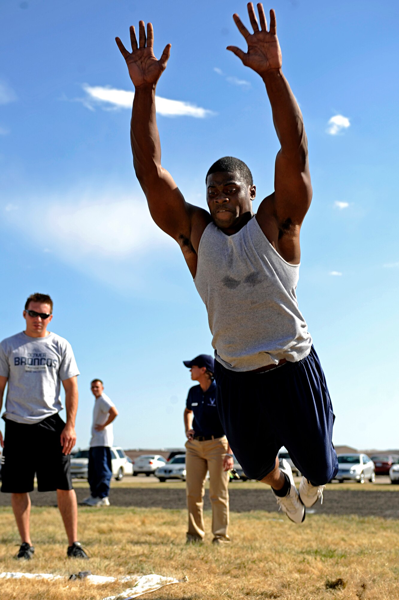 Airman 1st Class Tremain Knowles, 28th Aircraft Maintenance Squadron crew chief, performs a standing jump during a football competition held here, Sept. 10. The competition was open to the base populace and tested various football skills. (Airman 1st Class Matthew Flynn)