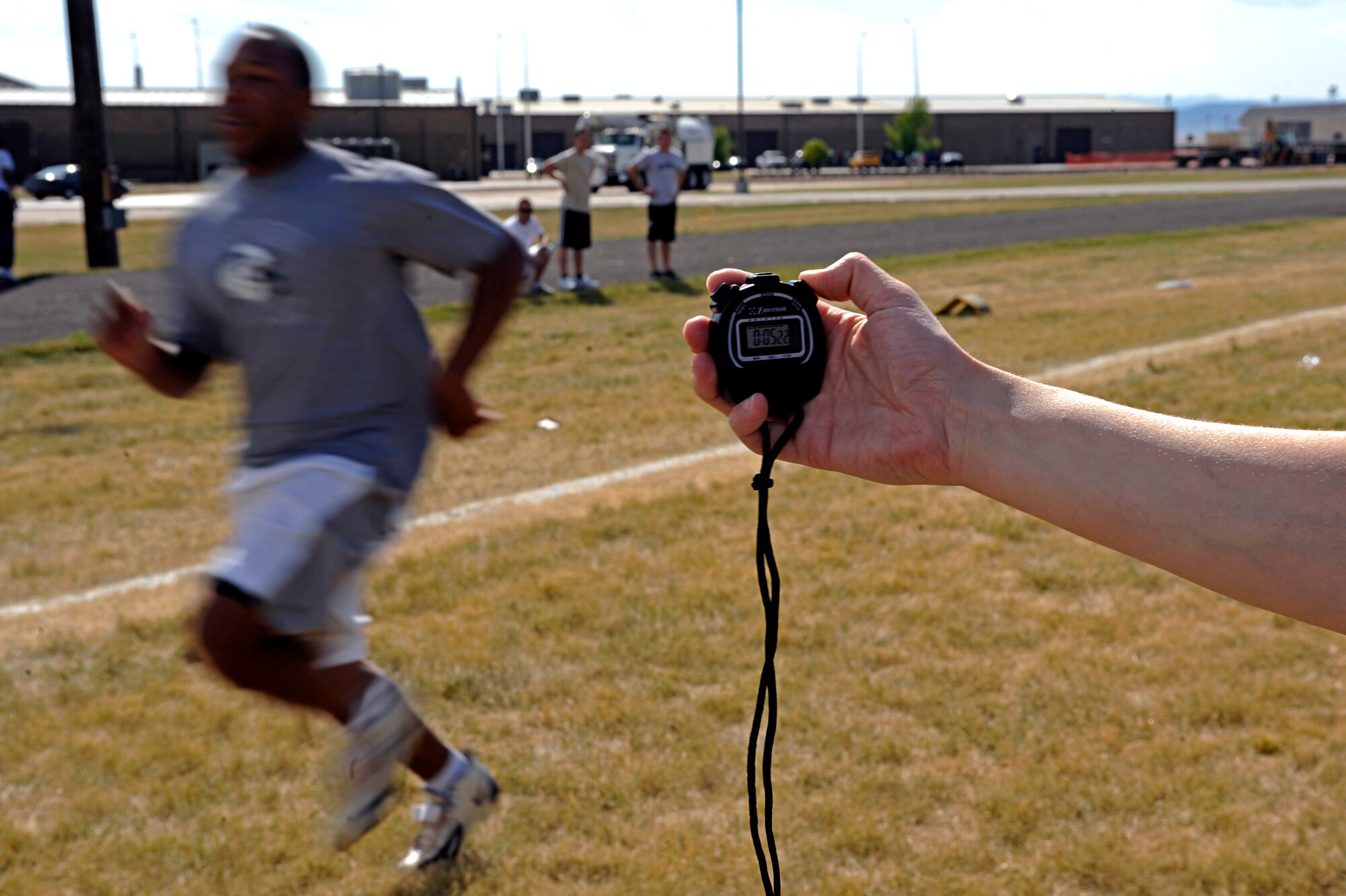 (Right) Tech. Sgt. Kathy Gatzke, 28th Force Support Squadron section chief, times 1st Lt. Overton Spence, 28th Comptroller and Contracting Squadron deputy flight chief, during a 40-yard dash here, Sept. 10. Lieutenant Spence competed against five other Airmen in a football competition open to the base populace to test the contestants’ various football skills. (U.S. Air Force photo/Airman 1st Class Matthew Flynn)