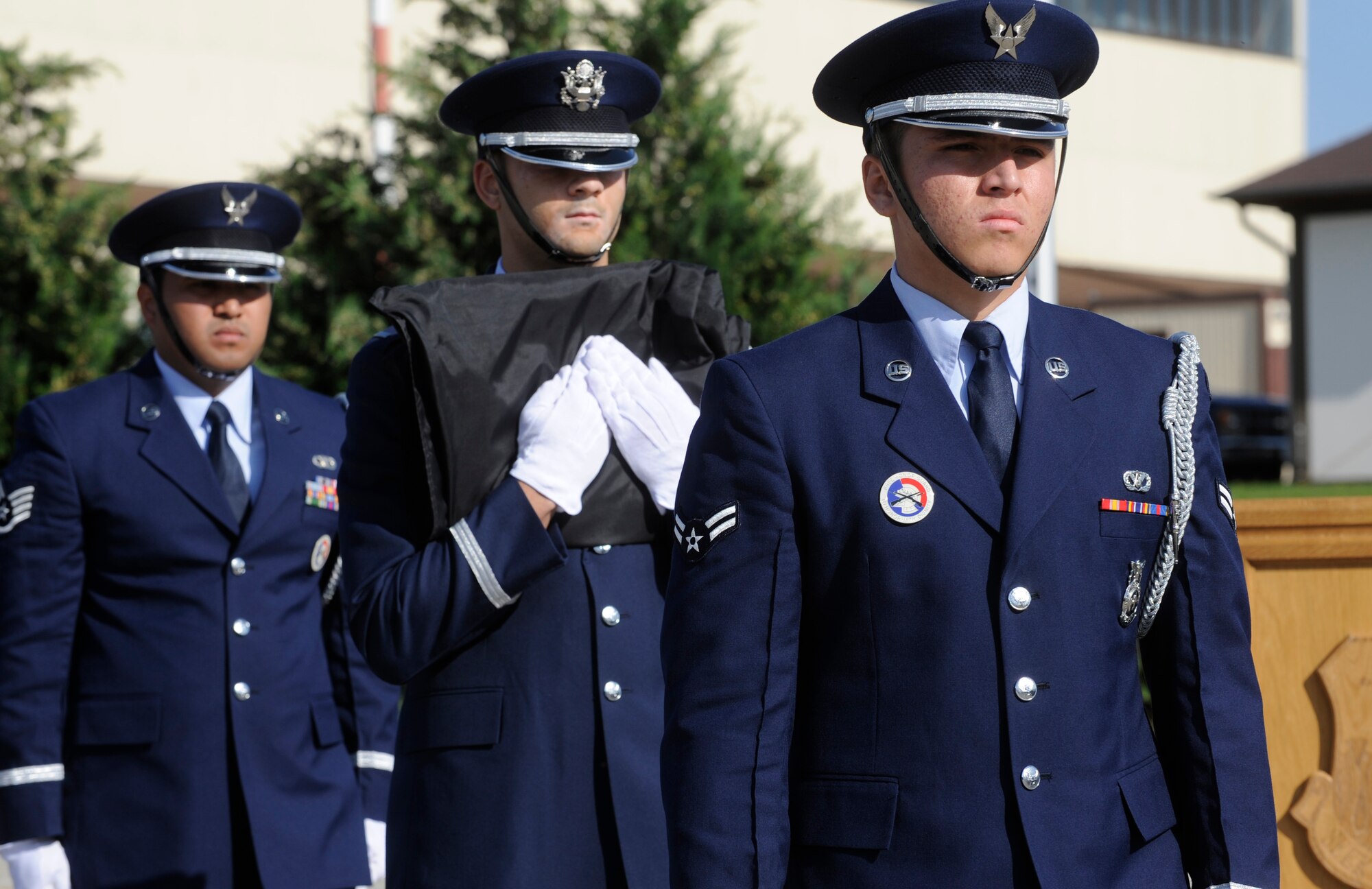 SPANGDAHLEM AIR BASE Germany – Base Honor Guardsmen Airman 1st Class Anthony Alvarez, 1st Lt. Christopher McDaniels and Staff Sgt. Arturo Visarraga escort the German flag from the 52nd Fighter Wing headquarters’ building flag poles during a Sept. 11 retreat ceremony.  Approximately 200 people from the 52nd FW and tenant units attended the ceremony put together by the First IV.  (U.S. Air Force photo/Master Sgt. Bill Gomez)