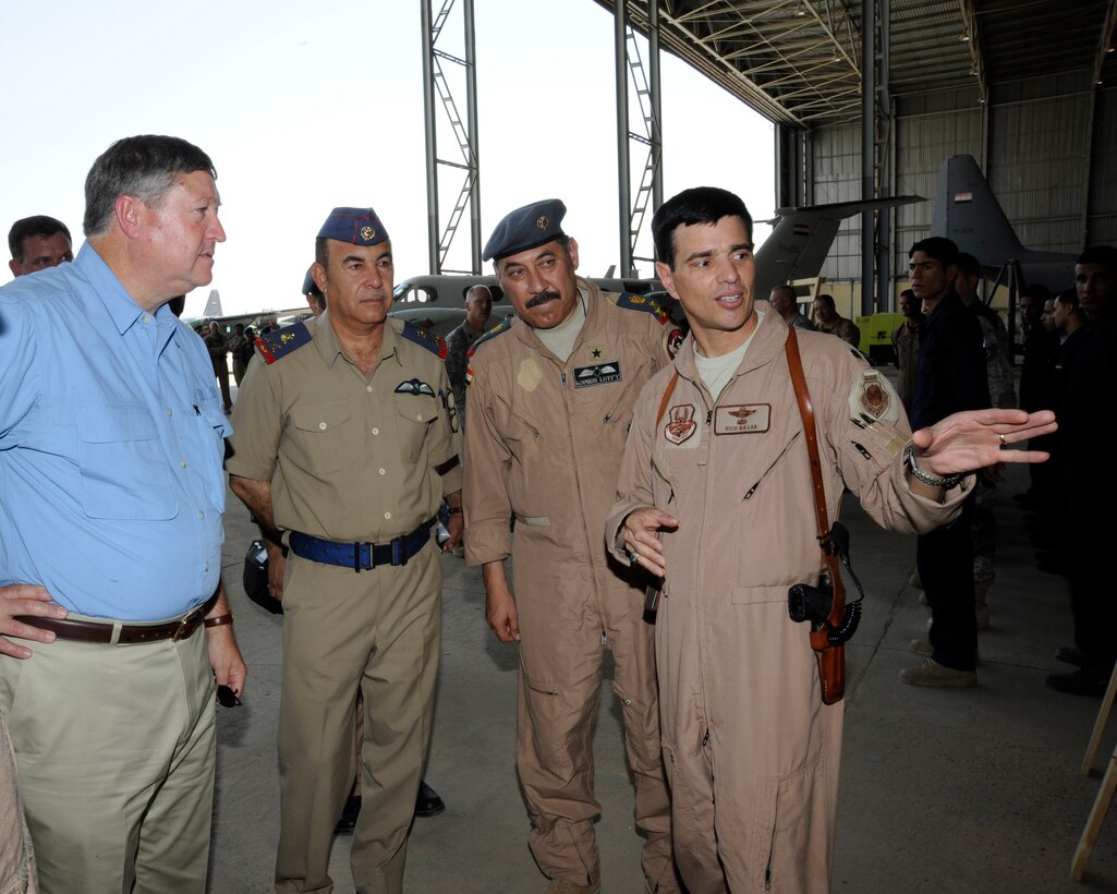 NEW AL MUTHANNA AIR BASE, Iraq -- Air Force Lt. Col. Richard Basak (right), Iraqi Training and Advisory Mission - Air Force chief of air operations military training team, briefs Secretary of the Air Force Michael Donley here while Iraqi air staff officers look on Aug. 27, 2009. Mr. Donley received a tour of the Iraqi air base, which included aircraft displays and storyboard briefings. Later he visited Camp Taji where he held an Airman’s call and addressed both U.S. and Iraqi Airmen. Colonel Basak is deployed from Langley Air Force Base, Va., and hails from Patchogue, N.Y. (U.S. Air Force photo/Tech. Sgt. Johnny L. Saldivar)