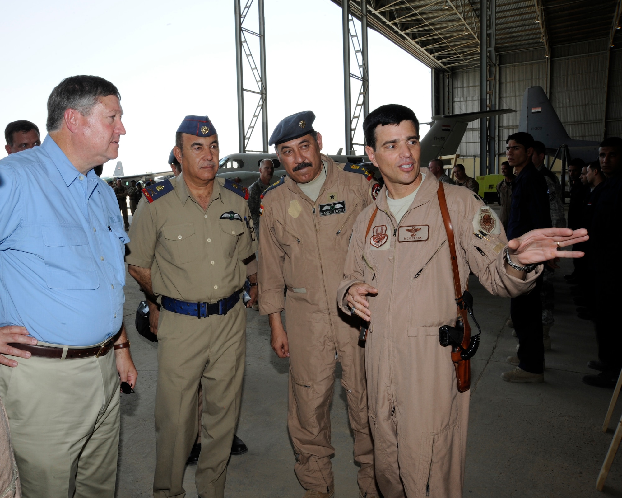 NEW AL MUTHANNA AIR BASE, Iraq -- Air Force Lt. Col. Richard Basak (right), Iraqi Training and Advisory Mission - Air Force chief of air operations military training team, briefs Secretary of the Air Force Michael Donley here while Iraqi air staff officers look on Aug. 27, 2009. Mr. Donley received a tour of the Iraqi air base, which included aircraft displays and storyboard briefings. Later he visited Camp Taji where he held an Airman’s call and addressed both U.S. and Iraqi Airmen. Colonel Basak is deployed from Langley Air Force Base, Va., and hails from Patchogue, N.Y. (U.S. Air Force photo/Tech. Sgt. Johnny L. Saldivar)