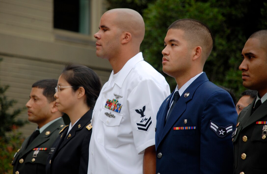 WASHINGTON -- Airman 1st Class Carlo Santiago stands with service members during the Presentation of Candidates during a U.S. Military Naturalization Ceremony, Sept. 10, 2009, at the Pentagon. During the ceremony Secretary of Defense Robert Gates thanked the 31 service members for their service and Secretary of Homeland Security Janet Napolitano led them with the oath of allegiance. (U.S. Air Force Photo/Master Sgt. Stan Parker)