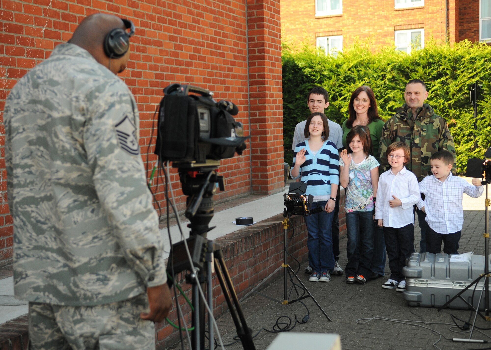 RAF MILDENHALL, England - Master Sgt. Antonio Prospst, Defense Media Activity broadcaster, San Antonio, videos the William’s family for the “Hometown Holiday Greetings” program Sept 12, 2009. While servicemembers and their families serve their tours overseas, the recorded message broadcast on local television stations for families in the states to see during the holiday season. (U.S. Air Force photo/ Staff Sergeant Jerry Fleshman)