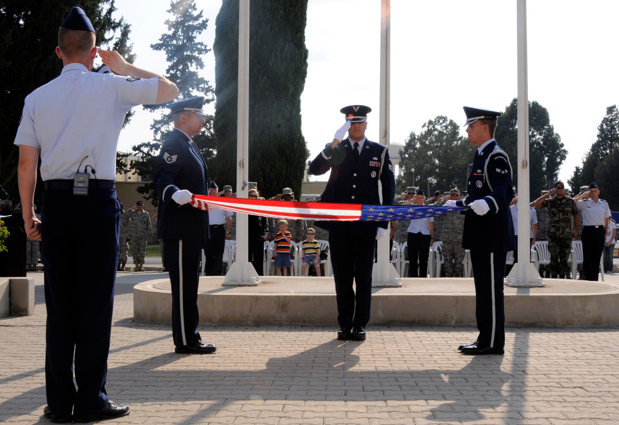 Incirlik American and Turkish personnel pay tribute to the American flag during the 9/11 Remembrance Ceremony Sept. 11, 2009 at Incirlik Air Base, Turkey.  Members from the Airmen Committed to Excellence club helped organize the ceremony for the base populace. Both American and Turkish personnel were present at the flag pole in support of the eighth anniversary of the terror attacks on America. (U.S. Air Force photo/Airman 1st Class Amber Ashcraft)