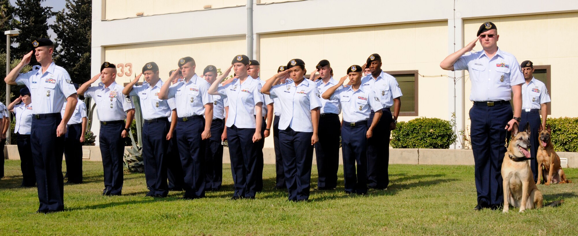 Airmen from the 39th Security Forces Squadron salute the flag during the playing of the nation anthem at the 9/11 Remembrance Ceremony Sept. 11, 2009 at Incirlik Air Base, Turkey. Members from the Airmen Committed to Excellence club helped organize the ceremony for the base populace. Both American and Turkish personnel were present at the flag pole in support of the eighth anniversary of the terror attacks on America. (U.S. Air Force photo/Airman 1st Class Amber Ashcraft)