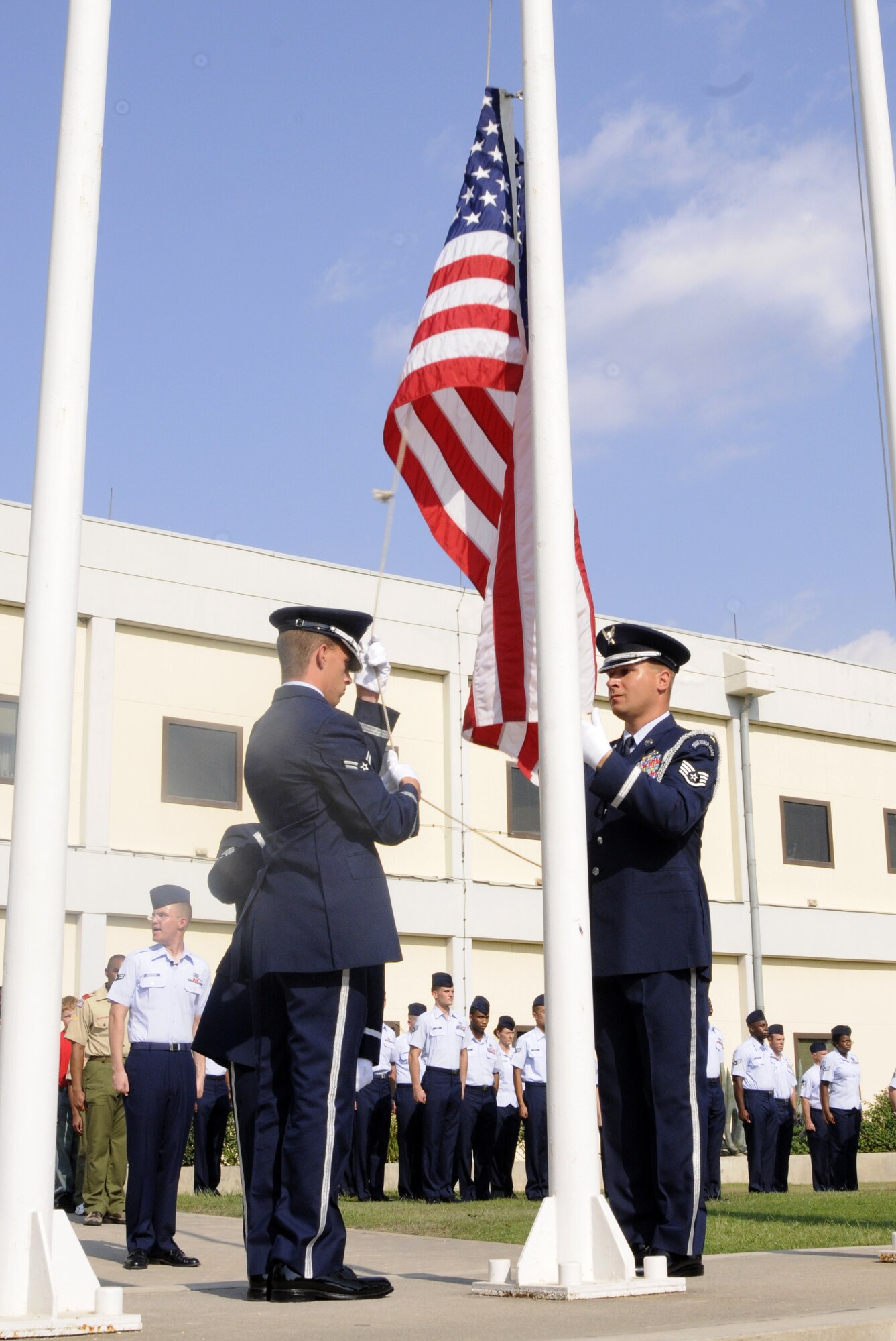 Airmen from Incirlik’s Honor Guard lower the flag to half mast during the 9/11 Remembrance Ceremony Sept. 11, 2009 at Incirlik Air Base, Turkey. Members from the Airmen Committed to Excellence club helped organize the ceremony for the base populace. Both American and Turkish personnel were present at the flag pole in support of the eighth anniversary of the terror attacks on America. (U.S. Air Force photo/Airman 1st Class Amber Ashcraft)