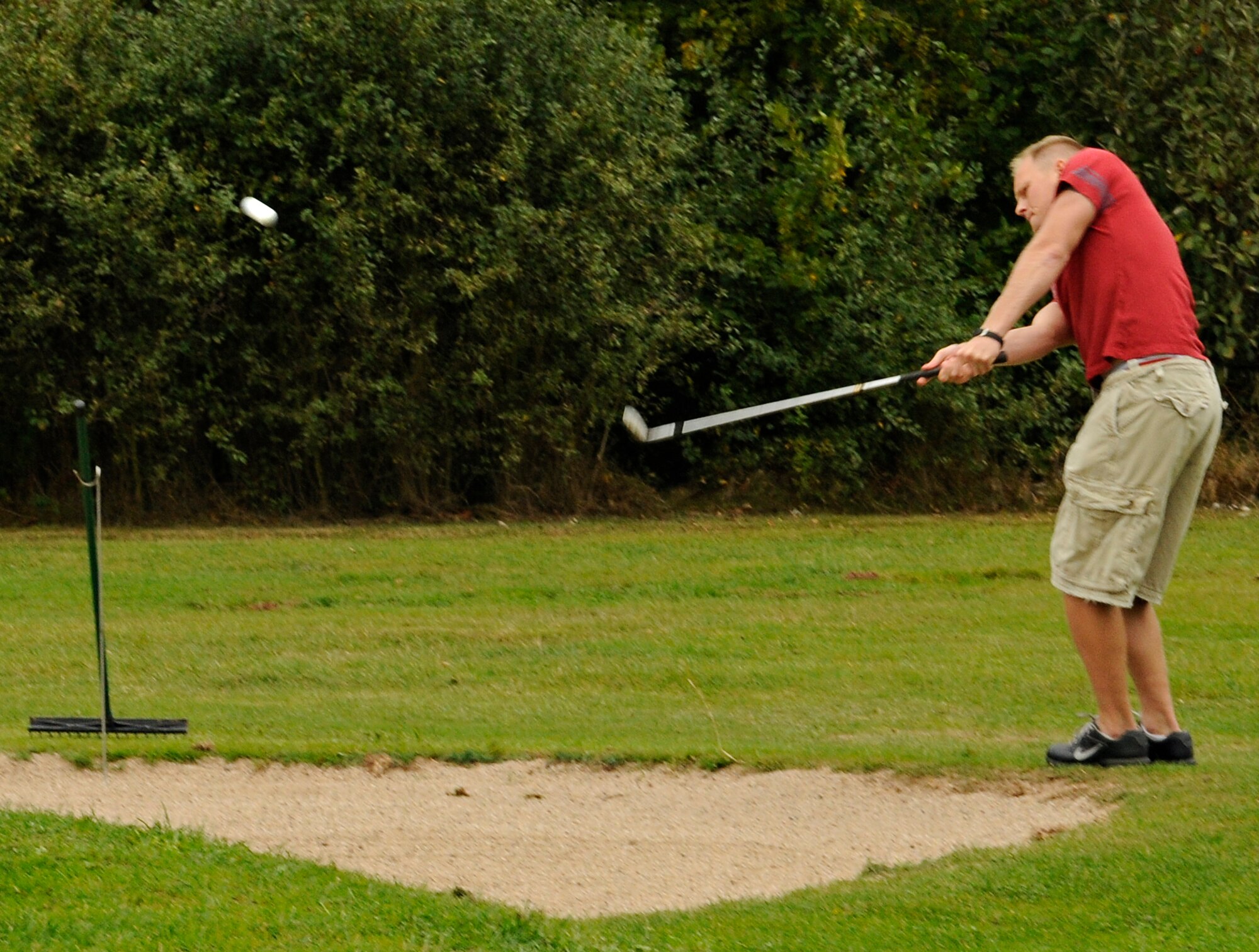 SPANGDAHLEM AIR BASE, Germany – Eric Ackerman, 52nd Communications Squadron, chips his ball over a sand trap and onto the green of the Eifel Mountain Golf Course’s first hole during the base championship match Sept. 10. Ackerman’s team, 52nd CS, took first place in a recent single elimination tournament beating the top eight teams of the regular golf season. (U.S. Air Force photo/Senior Airman Benjamin Wilson)