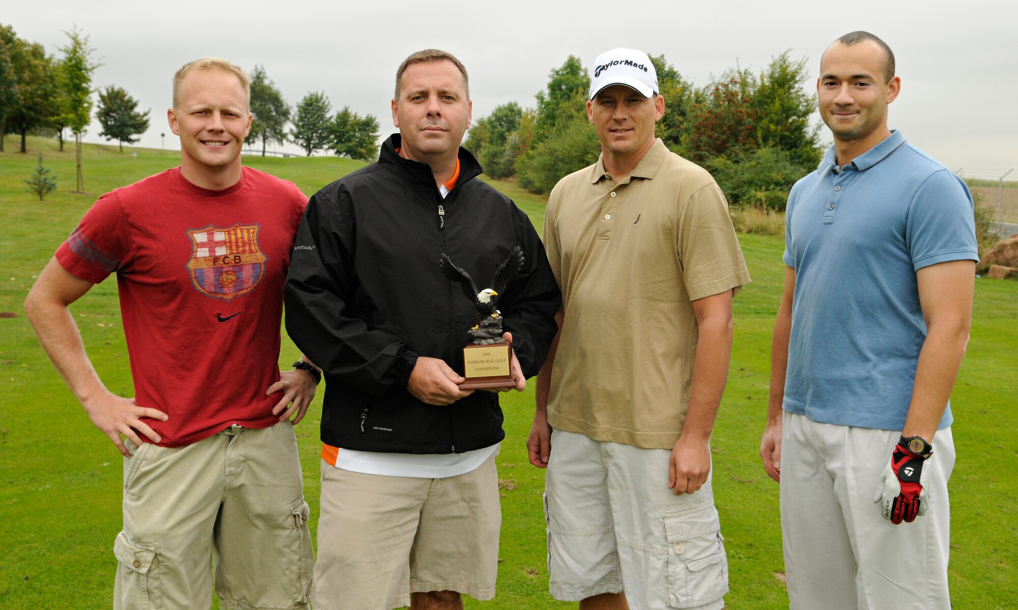 SPANGDAHLEM AIR BASE, Germany – The 52nd Communications Squadron golf team, (from left) Eric Ackerman, 52nd CS; Clifton King, American Forces Network-Spangdahlem; Tracey Jones, 52nd CS; and Chris McDaniels, 52nd CS, poses with the Spangdahlem 2009 Intramural Golf Championship Trophy on the first hole of the Eifel Mountain Golf Course Sept. 10. Eleven golf teams from Spangdahlem Air Base and its geographically separated units competed in the regular golf season and the 52nd CS team beat the top eight teams in a single elimination tournament to take first place. (U.S. Air Force photo/Senior Airman Benjamin Wilson)