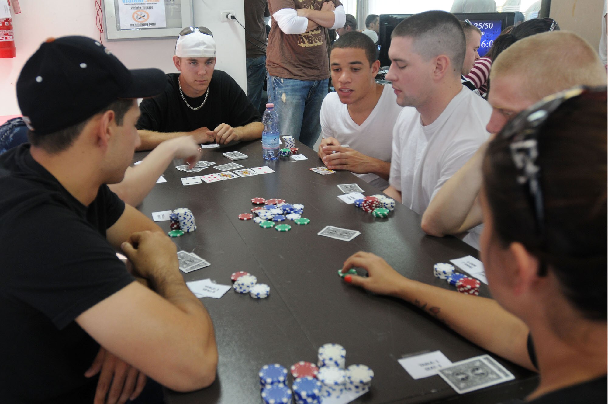 Aviano Airmen compete in a Texas Hold'em tournament to win an Xbox 360 game system at the Second Annual Airman's Bash Sept. 12, 2009 at the 'I Visinai Sports Complex' in Aviano. More than 100 Airmen grades E-1 to E-4 and their families attended the free event, which included a variety of tournaments, live music, food and prizes. Giveaways included a Play Station 3, Blu-ray DVD player, Apple I-Pods, AAFES gift cards and 31st Force Support Squadron recreational gift cards.  (U.S. Air Force photo/Airman 1st Class Ashley Wood)