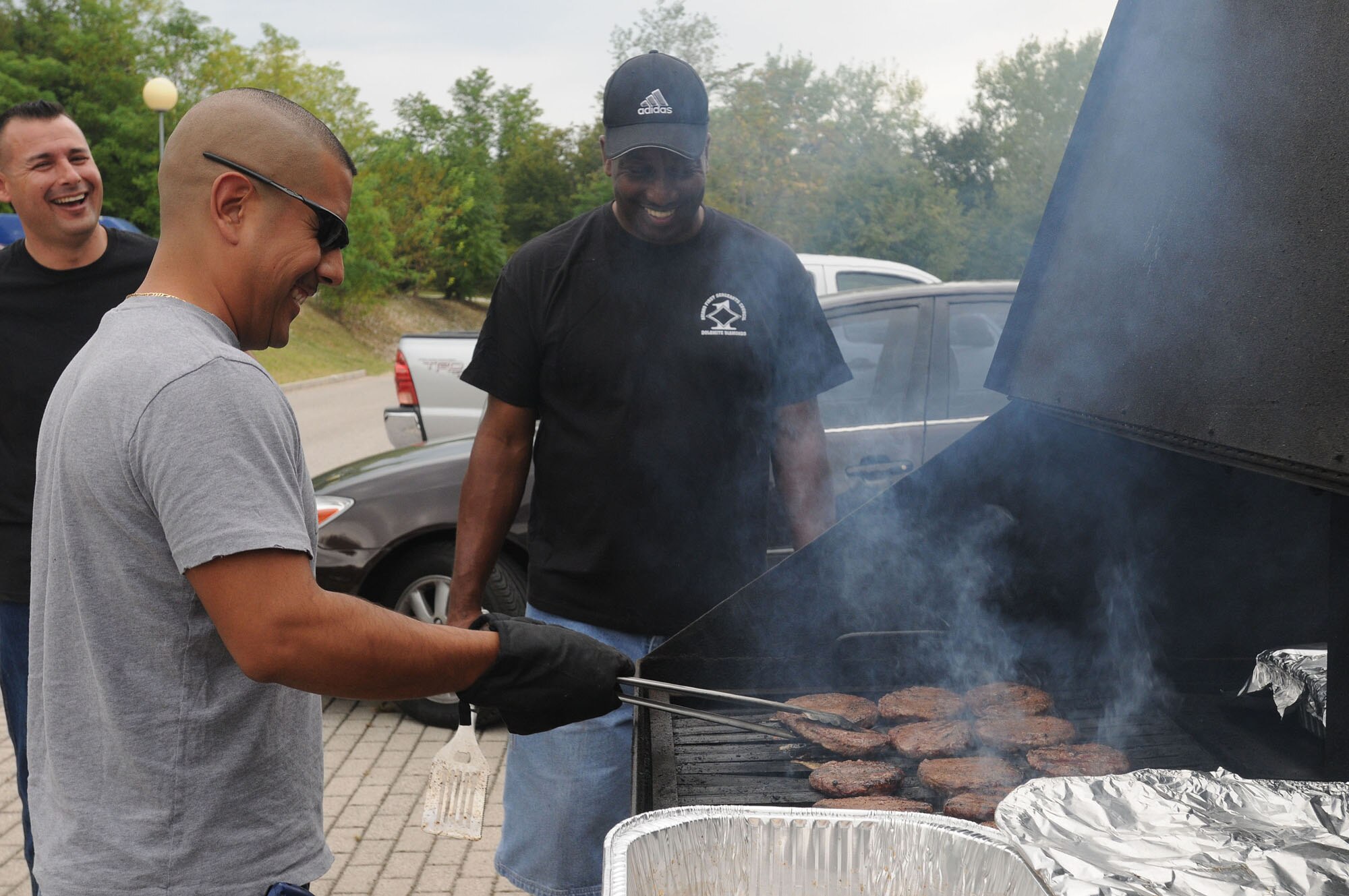 Aviano first sergeants cook burgers and hot dogs during the Second Annual Airmen's Bash Sept. 12, 2009 at the 'I Visinai Sports Complex' in Aviano. More than 100 Airmen grades E-1 to E-4 and their families attended the free event, which included a variety of tournaments, live music, food and prizes. (U.S. Air Force photo/Airman 1st Class Ashley Wood)