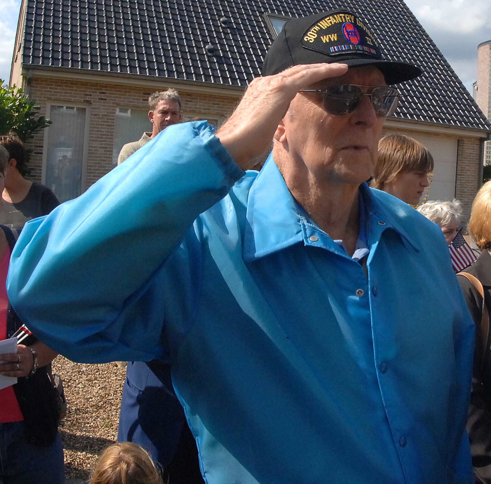 SPANGDAHLEM AIR BASE, Germany -- Former Private 1st Class Frank Deegan, 30th Infantry Division, salutes during the American National Anthem and the presenting of colors at the Liberation of Belgium Memorial Event in Fouron le Comte, Belgium, Sept 6. Mr. Deegan received an "Honorary Citizen of the Town" certificate from the town for wounds he received there during the liberation of Belgium Sept. 12, 1944. (U.S. Air Force photo/Airman 1st Class Nick Wilson) 