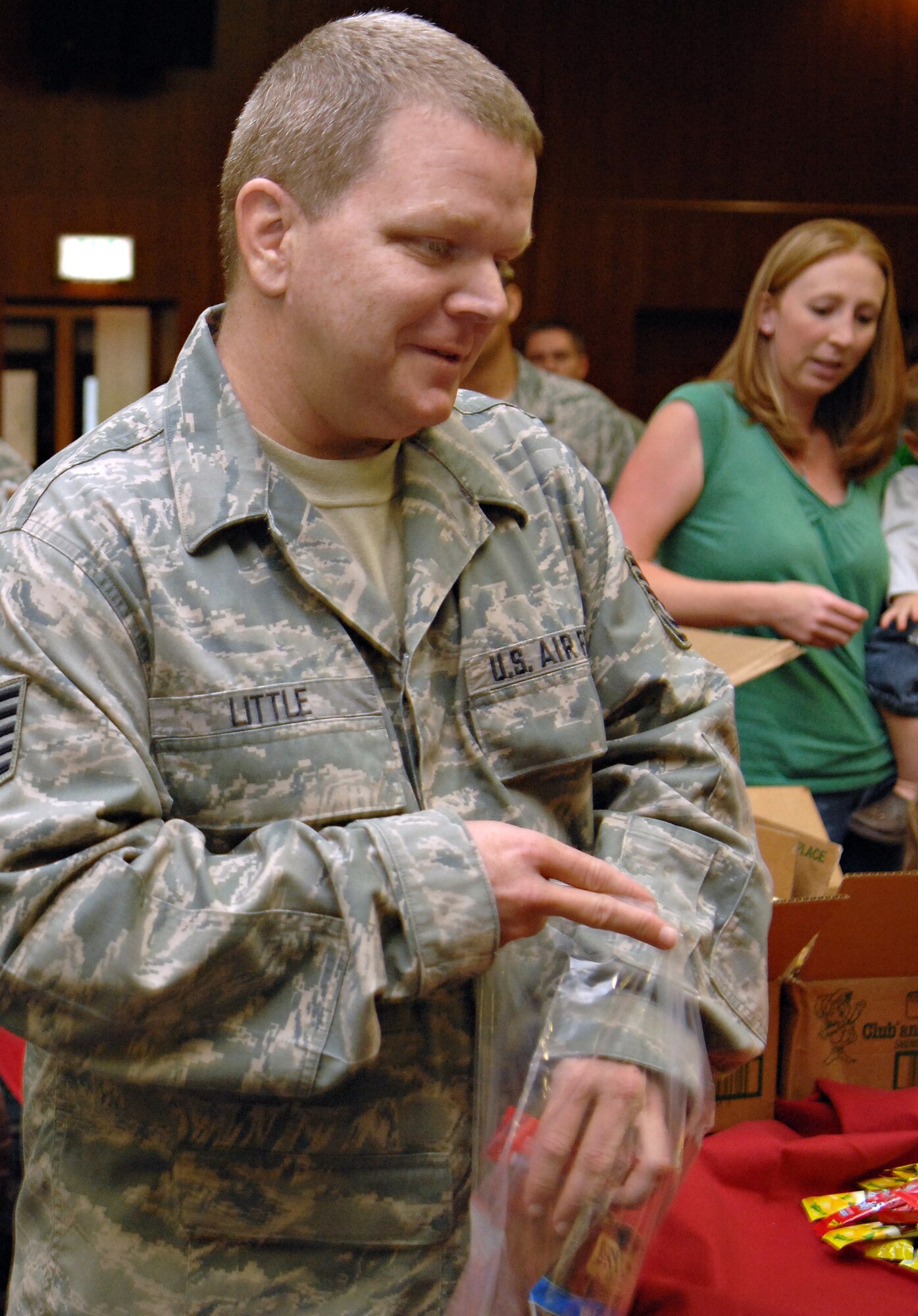 SPANGDAHLEM AIR BASE, Germany – Tech. Sgt. Terry Little, 606th Air Control Squadron, packs a care package with snacks while volunteering for Operation Open Arms Sept. 10 at Club Eifel. More than 100 volunteers packed approximately 1,100 care packages to be given to deploying and returning Airmen in Spangdahlem’s Air Mobility Command’s terminal. Operation Open Arms is funded by donations from various base organizations and began in March 2006. (U.S. Air Force photo/Senior Airman Benjamin Wilson)