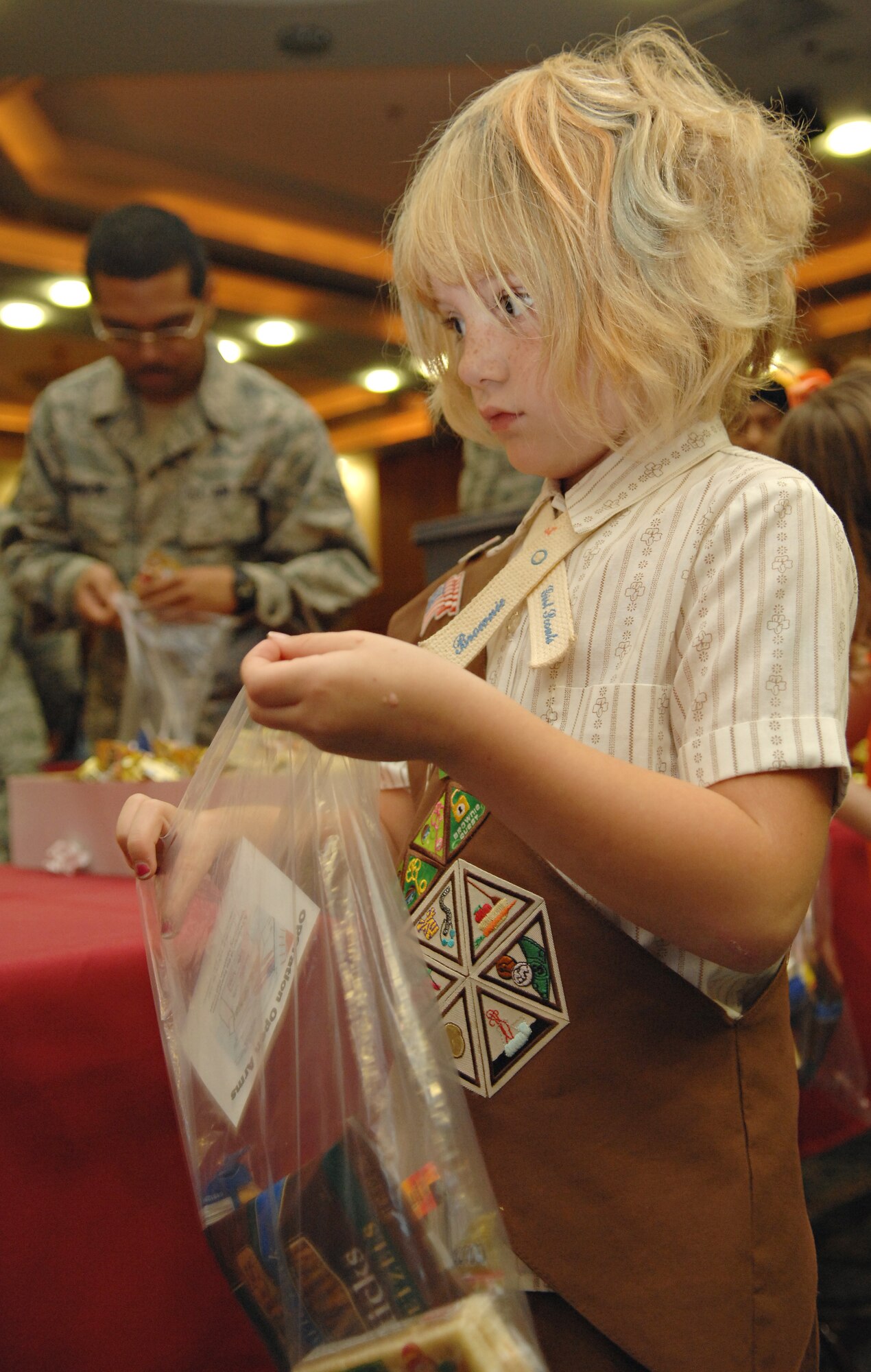 SPANGDAHLEM AIR BASE, Germany – Abigail Mein, daughter of Tech. Sgt. Loren Mein, 52nd Civil Engineer Squadron, packs a care package with snacks while volunteering for Operation Open Arms Sept. 10 at Club Eifel. More than 100 volunteers packed approximately 1,100 care packages to be given to deploying and returning Airmen at Spangdahlem’s Air Mobility Command’s terminal. Operation Open Arms is funded by donations from various base organizations and began in March 2006. (U.S. Air Force photo/Senior Airman Benjamin Wilson)