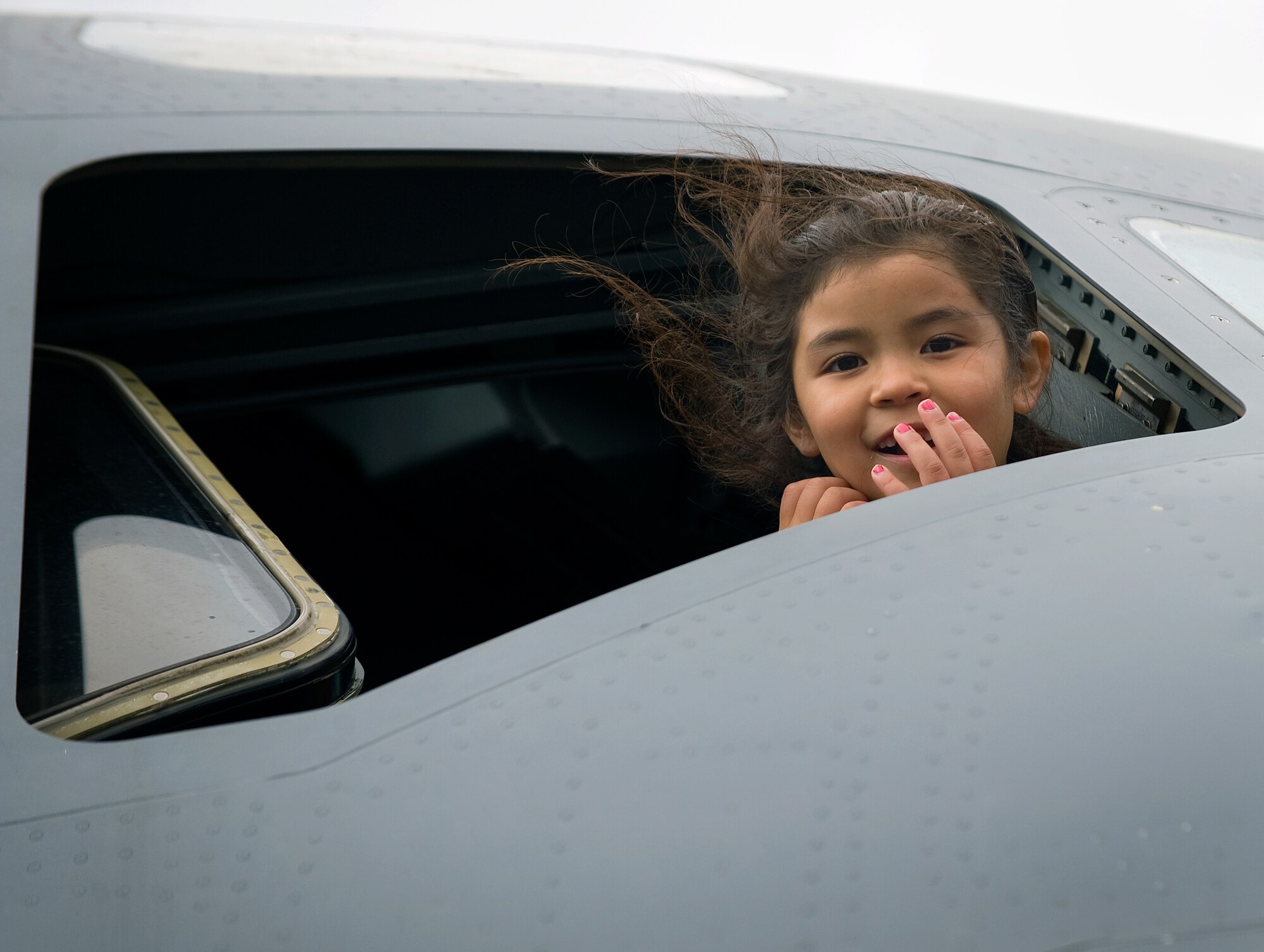 Itzel Rodriguez, 6 years old, peers out from the cockpit window of a C-17 Globemaster III Sept. 12, 2009, during the California Capital Air Show, the culminating event of Air Force Week Sacramento.  Air Force Week-Sacramento is an event featuring various activities and exhibitions to educate the community about the Air Force's capabilities and missions.  (U.S. Air Force photo/Staff Sgt. Bennie J. Davis III)