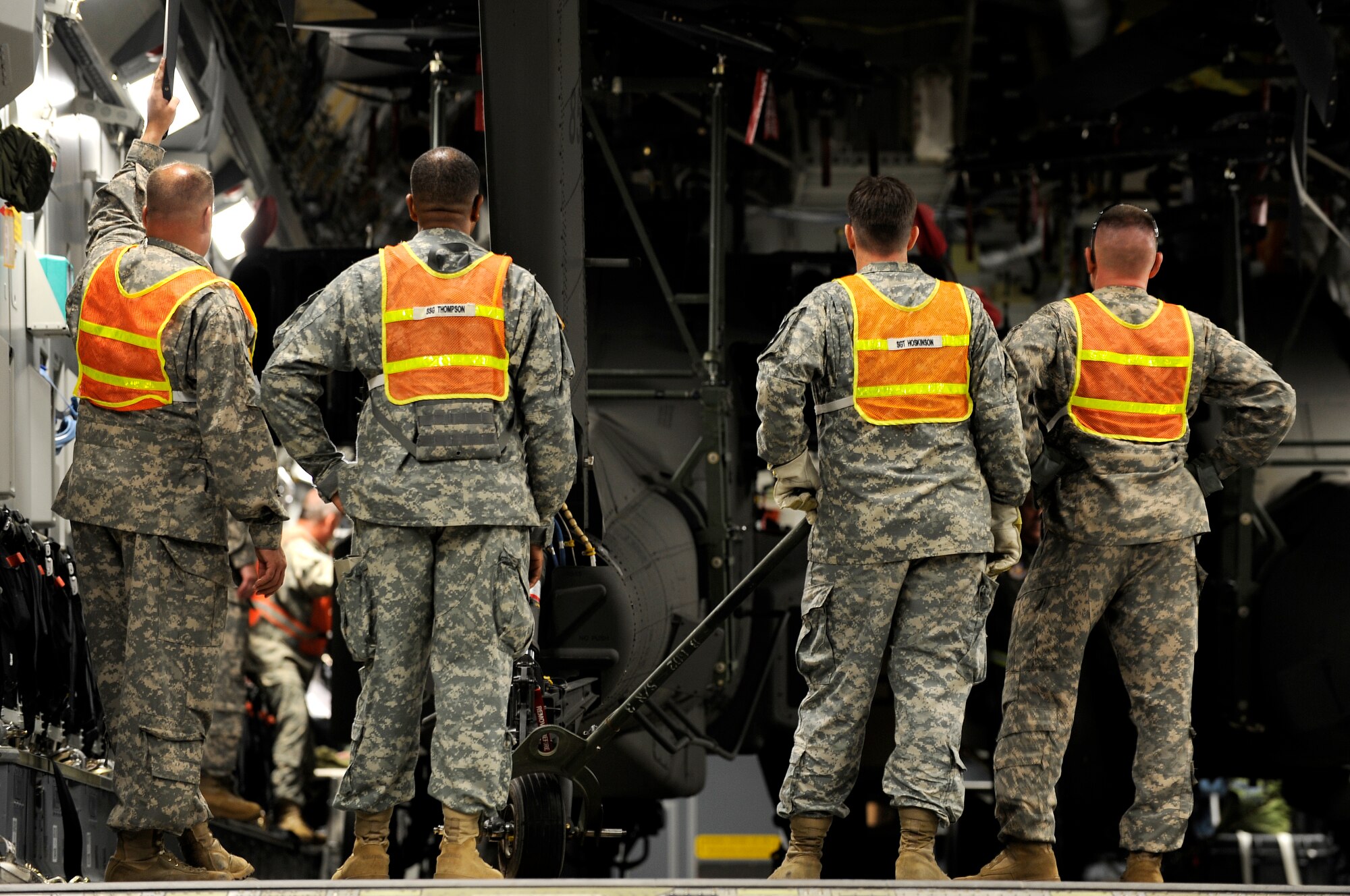Army soldiers from the 2nd Combat Aviation Brigade, Camp Humphreys, Republic of Korea, survey the situation before off-loading three new AH-64D Apache Longbows from a C-17 Globemaster III, Sept. 9, at Osan Air Base. These helicopters are the first of 24 the Army is swapping for the newer block II model over the next four months. (U.S. Air Force photo/Staff Sgt. Brian Ferguson)


