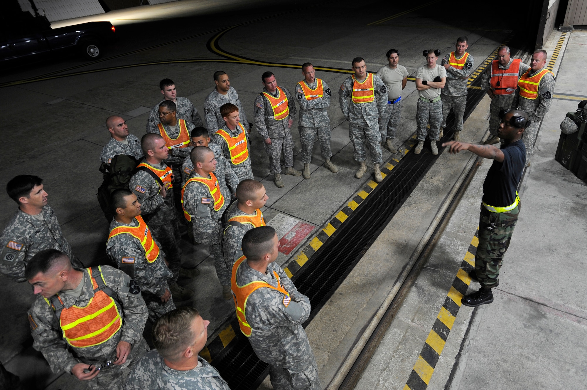 Soldiers from the 2nd Combat Aviation Brigade, Camp Humphreys, Republic of Korea, receive a safety brief from Staff Sgt. Lacarvia Heart before off-loading three new AH-64D Apache Longbows from a C-17 Globemaster III, Sept. 9, at Osan Air Base. These helicopters are the first of 24 the Army is swapping for the newer block II model over the next four months. Sergeant Heart is assigned to the 731st Air Mobility Squadron here.(U.S. Air Force photo/Staff Sgt. Brian Ferguson)


