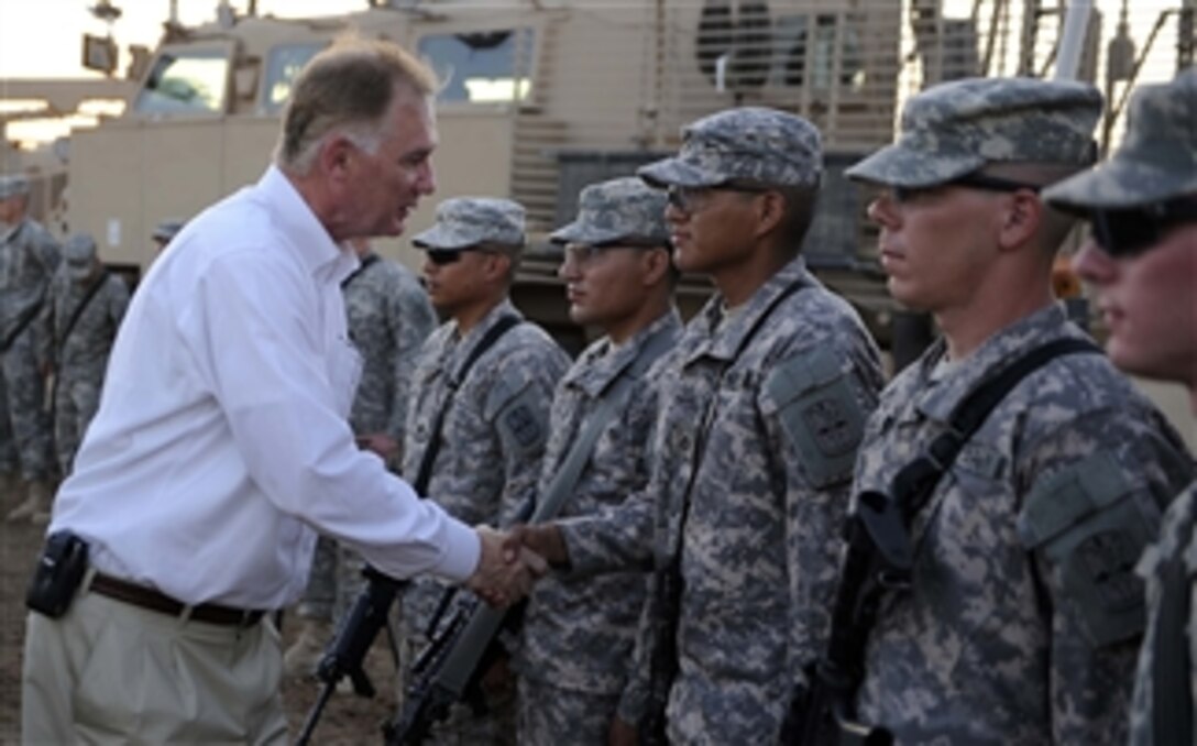 Deputy Secretary of Defense William J. Lynn III thanks soldiers from the 172nd Infantry Brigade Route Clearance Team for their service at Forward Operating Base Kalsu near Baghdad, Iraq, on Sept. 11, 2009.  