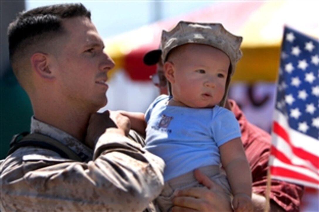 U.S. Marine Corps Capt. Justin Sharpe holds his 8-month-old son, Julian, after returning home to the Combat Center's Victory Field, Twentynine Palms, Calif., Sept. 8, 2009. Sharpe, the executive officer of Charlie Company, 3rd Light Armored Reconnaissance Battalion, was deployed to Iraq's Al Anbar province for the last seven months.