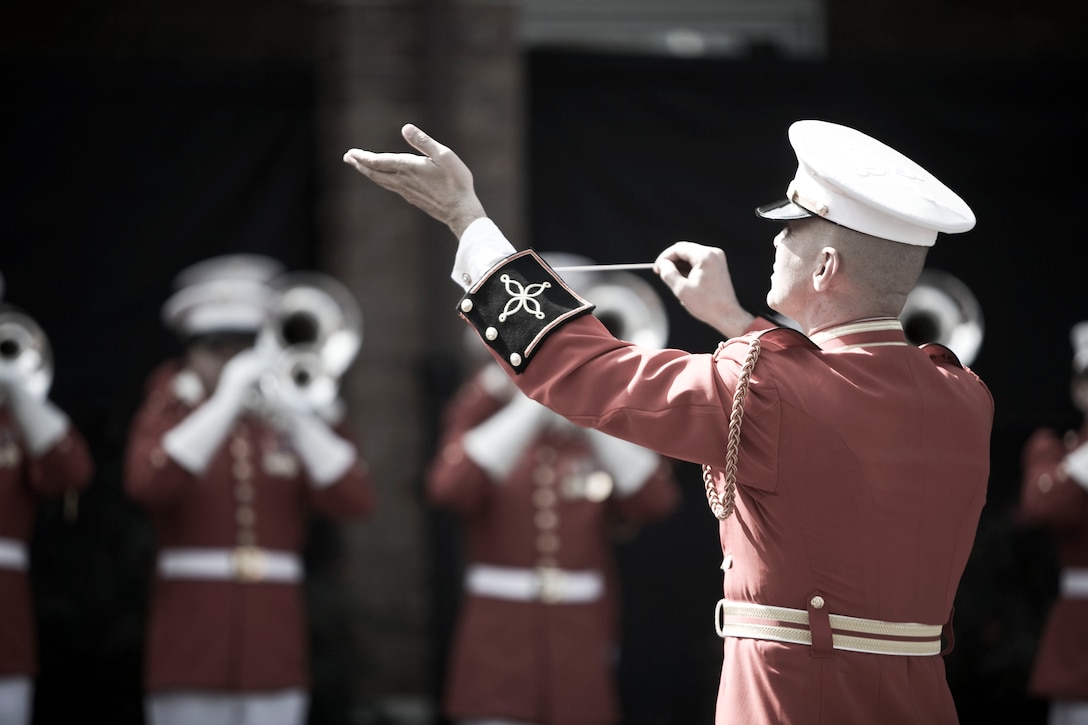 Chief Warrant Officer Brian J. Dix, U.S. Marine Drum and Bugle Corps director, leads the unit in the national anthem during the dedication ceremony of Colonel Truman W. Crawford Hall at Marine Barracks Washington, Sept. 14. The hall will serve as the new headquarters and rehearsal area for "The Commandant's Own."