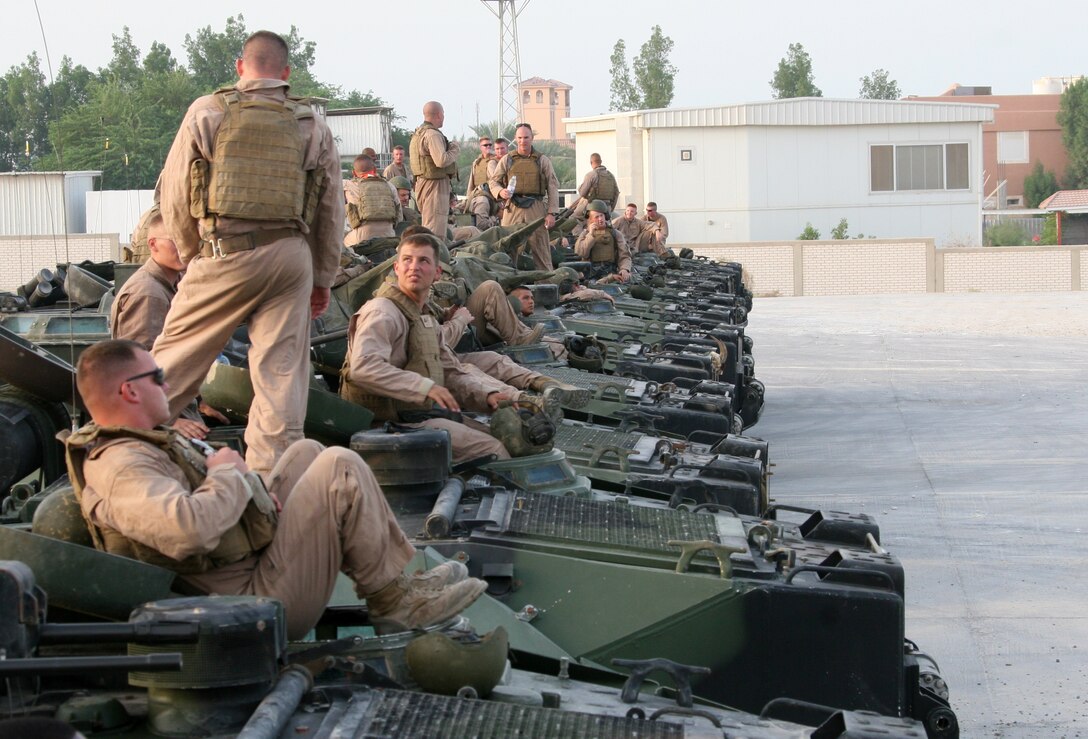 Marines with Amphibious Assault Vehicle Platoon, India Company, Battalion Landing Team, 3rd Battalion, 2nd Marine Regiment, 22nd Marine Expeditionary Unit, stand-by to move back to USS Fort McHenry (LSD 43) near Kuwait Naval Base, Sept. 14, 2009. The 22nd MEU was ashore in Kuwait for more than a month conducting sustainment training while serving as the theater reserve force for U.S. Central Command.::r::::n::(Official Marine Corps Photo by Cpl. Theodore W. Ritchie)