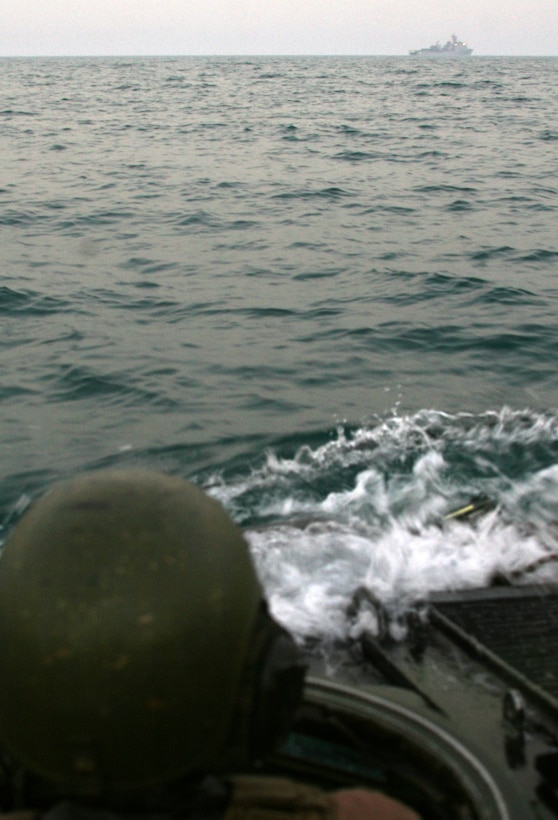 An Amphibious Assault Vehicle driver with AAV Platoon, India Company, Battalion Landing Team, 3rd Battalion, 2nd Marine Regiment, 22nd Marine Expeditionary Unit, maneuvers his AAV toward USS Fort McHenry (LSD 43) Sept. 14, 2009. The 22nd MEU was ashore in Kuwait for more than a month conducting sustainment training while serving as the theater reserve force for U.S. Central Command.::r::::n::(Official Marine Corps Photo by Cpl. Theodore W. Ritchie)