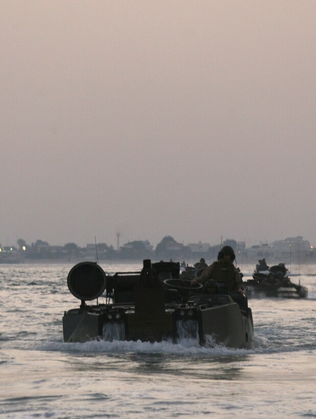 Amphibious Assault Vehicles from AAV Platoon, India Company, Battalion Landing Team, 3rd Battalion, 2nd Marine Regiment, 22nd Marine Expeditionary Unit, swim to the USS Fort McHenry (LSD 43) from Kuwait Naval Base, Sept. 14, 2009. The 22nd MEU was ashore in Kuwait for more than a month conducting sustainment training while serving as the theater reserve force for U.S. Central Command.::r::::n::(Official Marine Corps Photo by Cpl. Theodore W. Ritchie)