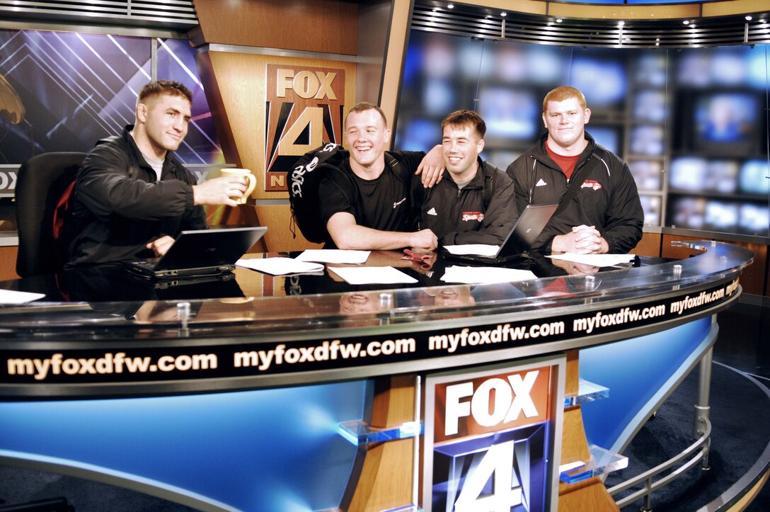 Cpl. Courtney J. Myers, Sgt. Steven M. Forrest, Sgt. Donavan G. Depatto and Cpl. Shawn M. Durfey, all members of the All-Marine Wresting Team, enjoy the set after making a guest appearance on Dallas' largest television morning news program, Fox 4 Good Day here Sept. 15. The wrestler's demonstrated techniques for the live broadcast while in between visits to local high schools throughout the Dallas-Fort Worth metroplex, hosting clinics for young wrestlers looking to start their careers.