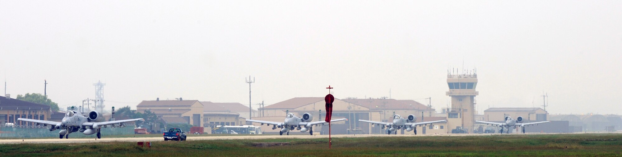 A-10 Thunderbolt IIs depart the runway at Osan Air Base, Republic of Korea, for Red Flag Alaska 10-01 Sept. 14.  Airmen from Osan will join Airmen from across the world to participate in Red Flag Alaska 10-01, scheduled for Oct. 1-16. The exercise is considered by many as the most intense training opportunity available to combat flying units. (U.S. Air Force photo/Senior Airman Stephenie Wade) 

