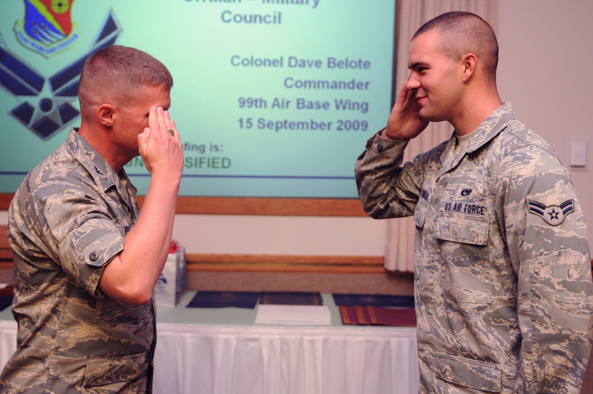 NELLIS AIR FORCE BASE, Nev. -- Col. Dave Belote, 99th Air Base Wing commander, presents the Maintainer of the Quarter Award to Airman 1st Class Bradley Batchelor, an avionics specialist assigned to the 57th Aircraft Maintenance Squadron, at the Civilian Military Council Luncheon, Sept. 15. Airman Bachelor was recognized by both the Las Vegas and Nellis community. Held every quarter, the Civilian Military Council Luncheon provides an open forum for Las Vegas and Nellis leaders to discuss up and coming issues.  (U.S. Air Force photo by Airman 1st Class Brett Clashman)