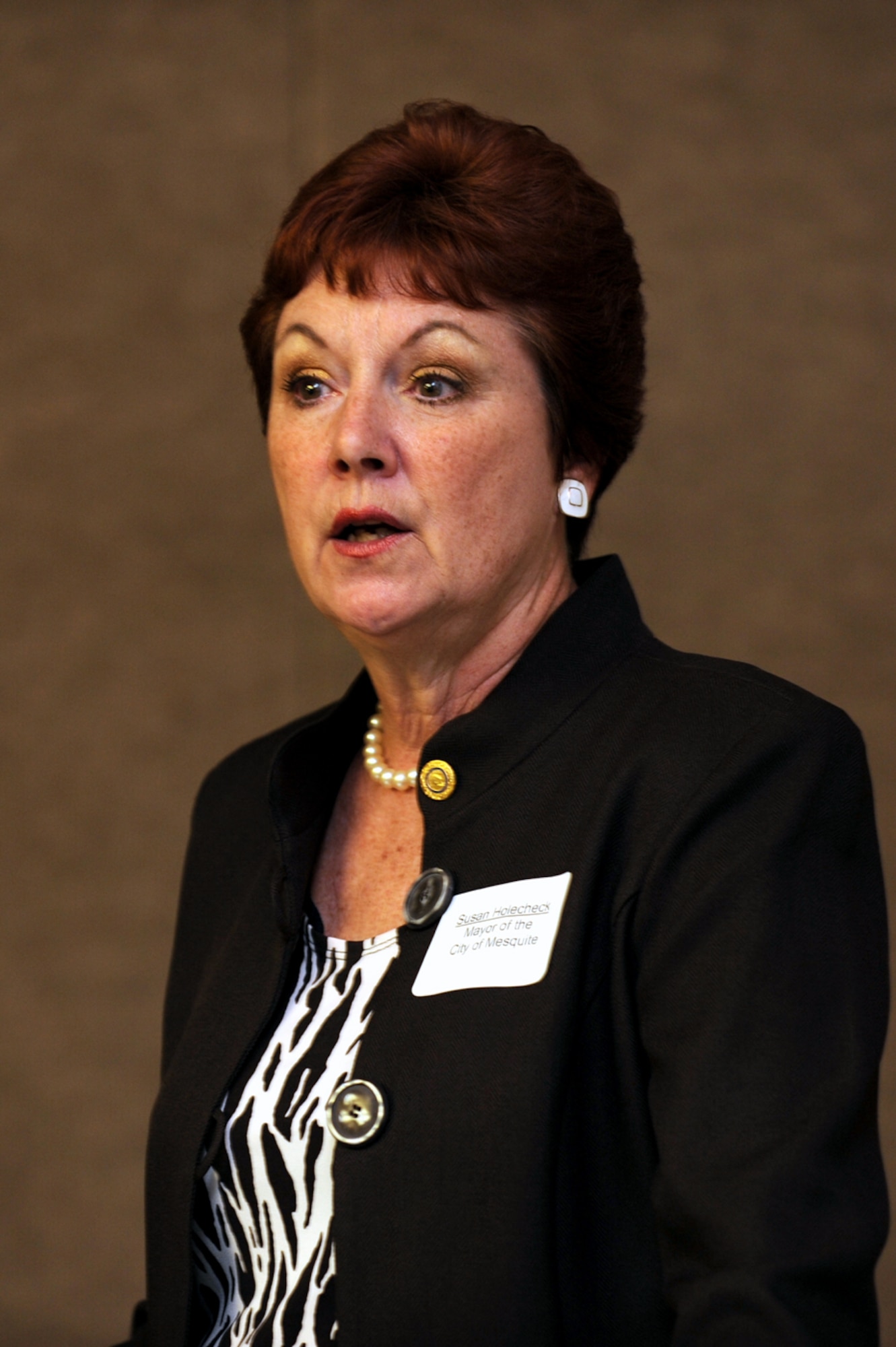 NELLIS AIR FORCE BASE, Nev.,-- Mayor Susan Holecheck, mayor of the city of Mesquite, Nev.,and this year's chairman of the Civilian Military Council Luncheon,  welcomes all Civilian Military Council Luncheon attendees, Sept.15. Held quarterly, the luncheon is an open forum where community leaders and Nellis leaders gather to discuss current events and recognize some outstanding Nellis Airmen. (U.S. Air Force photo by Airman 1st Class Brett Clashman)