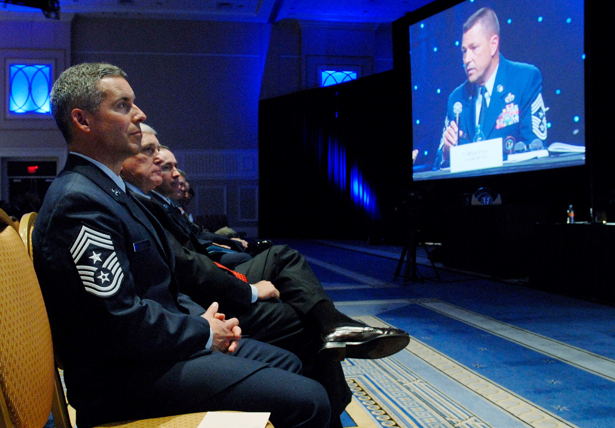 Chief Master Sgt. David Spector listens as Chief Master Sgt. W. Allen Usry, NORAD command chief, addresses conference attendees at the 2009 Air Force Association Air & Space Conference and Technology Exposition Sept. 15, 2009, in Washington, D.C. During the event the command chief panel discussed "Year of the Air Force Family," retention and quality of life for Airmen and their families. Chief Spector is the 20th Air Force command chief. (U.S. Air Force photo/Master Sgt. Stan Parker)