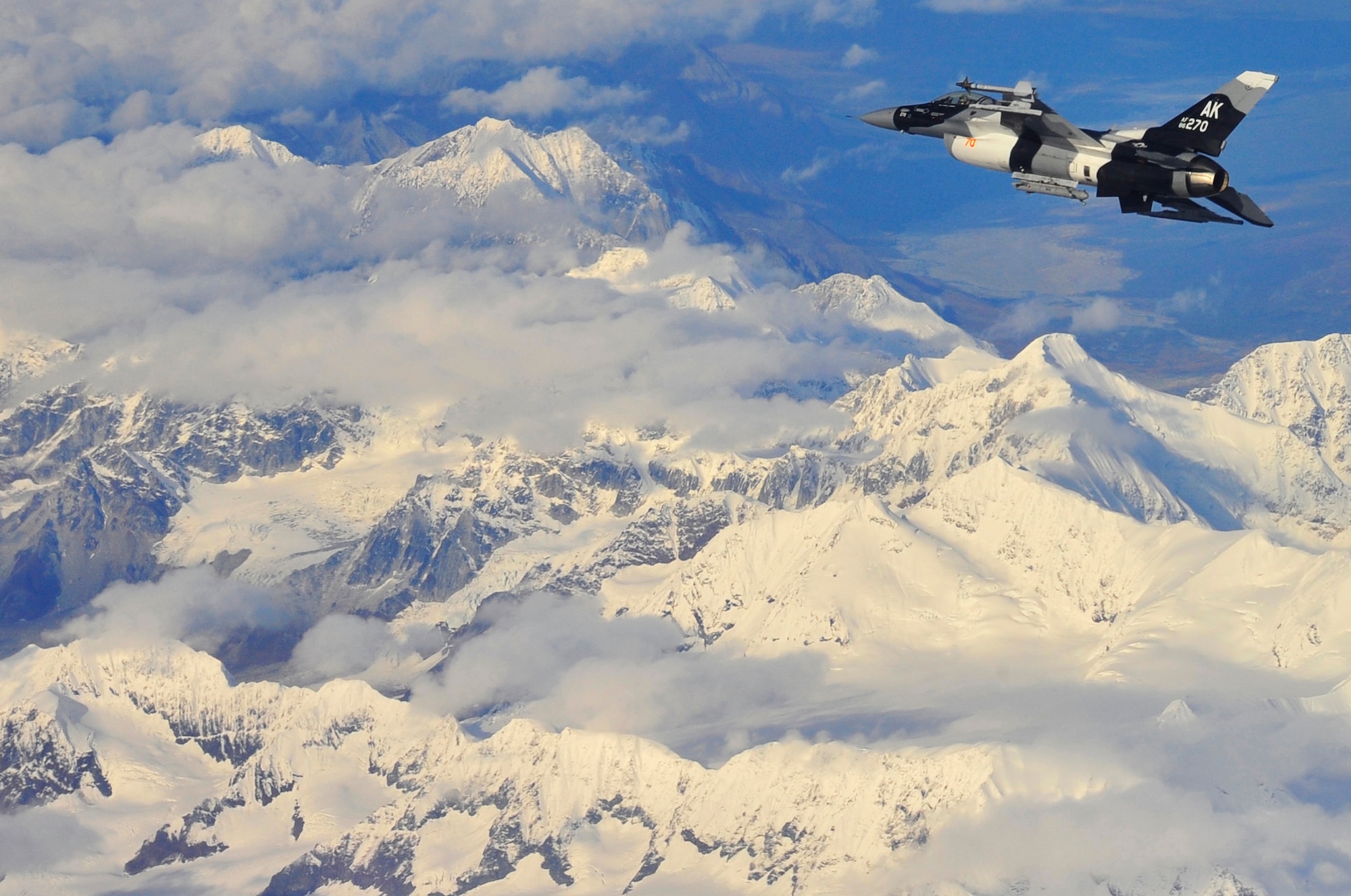An F-16 Aggressor soars above snow capped mountains in the Joint Pacific Alaska Range Complex Sept. 14, 2009, Eielson Air Force, Base, Alaska. The F-16 is assigned to the 18th Aggressor Squadron, which is responsible for training and preparing joint and allied aircrews for combat missions. (U.S. Air Force photo/Staff Sgt. Christopher Boitz)