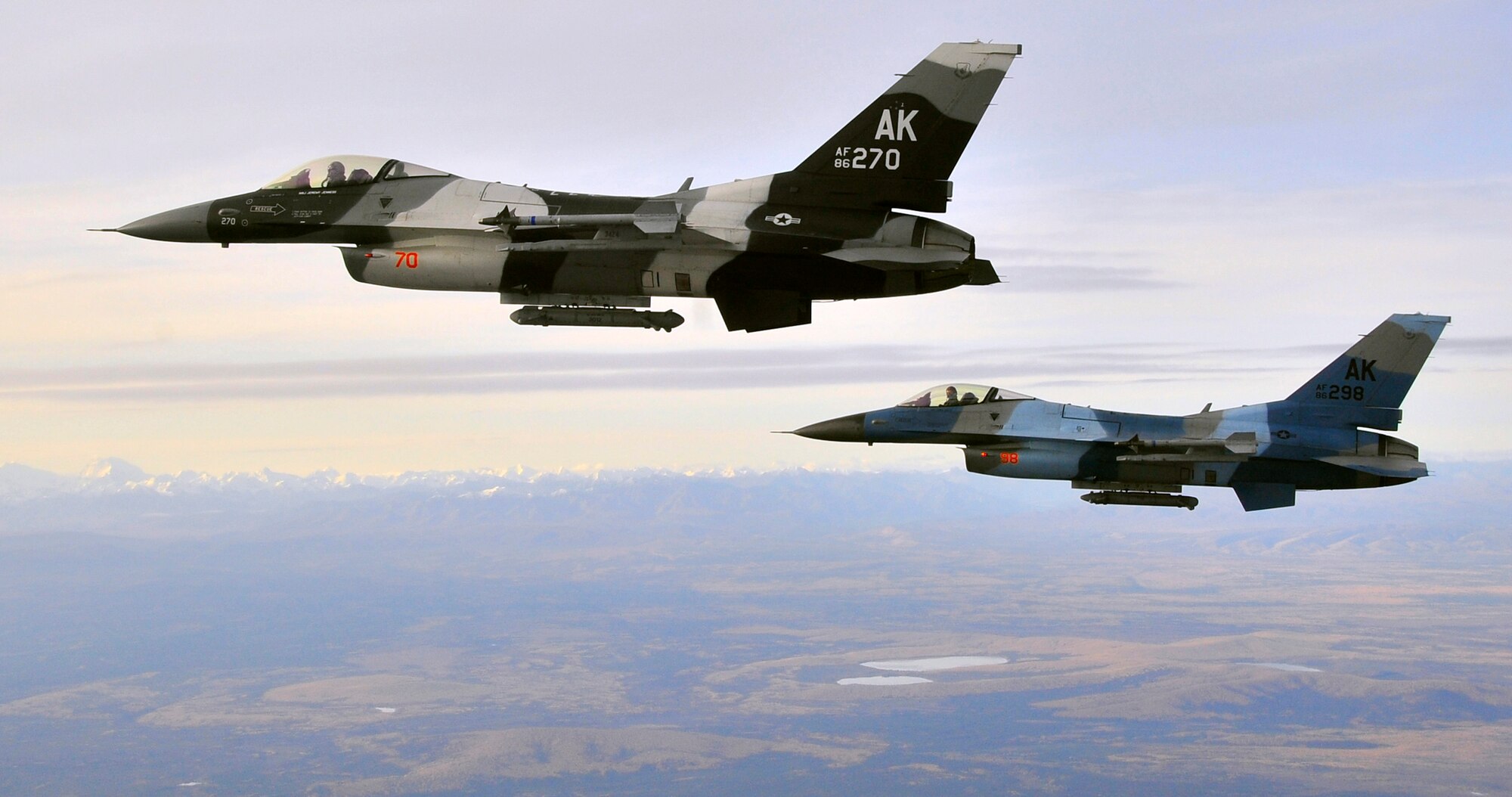 A pair of F-16 Aggressors fly over the Joint Pacific Alaska Range Complex Sept. 14, 2009, Eielson Air Force, Base, Alaska. The F-16s are assigned to the 18th Aggressor Squadron, which is responsible for training and preparing joint and allied aircrews for combat missions. The JPARC provides 67,000 square miles of airspace, one conventional bombing range and two tactical bombing ranges containing more than 400 different types of targets and more than 30 threat simulators. (U.S. Air Force photo/Staff Sgt. Christopher Boitz)